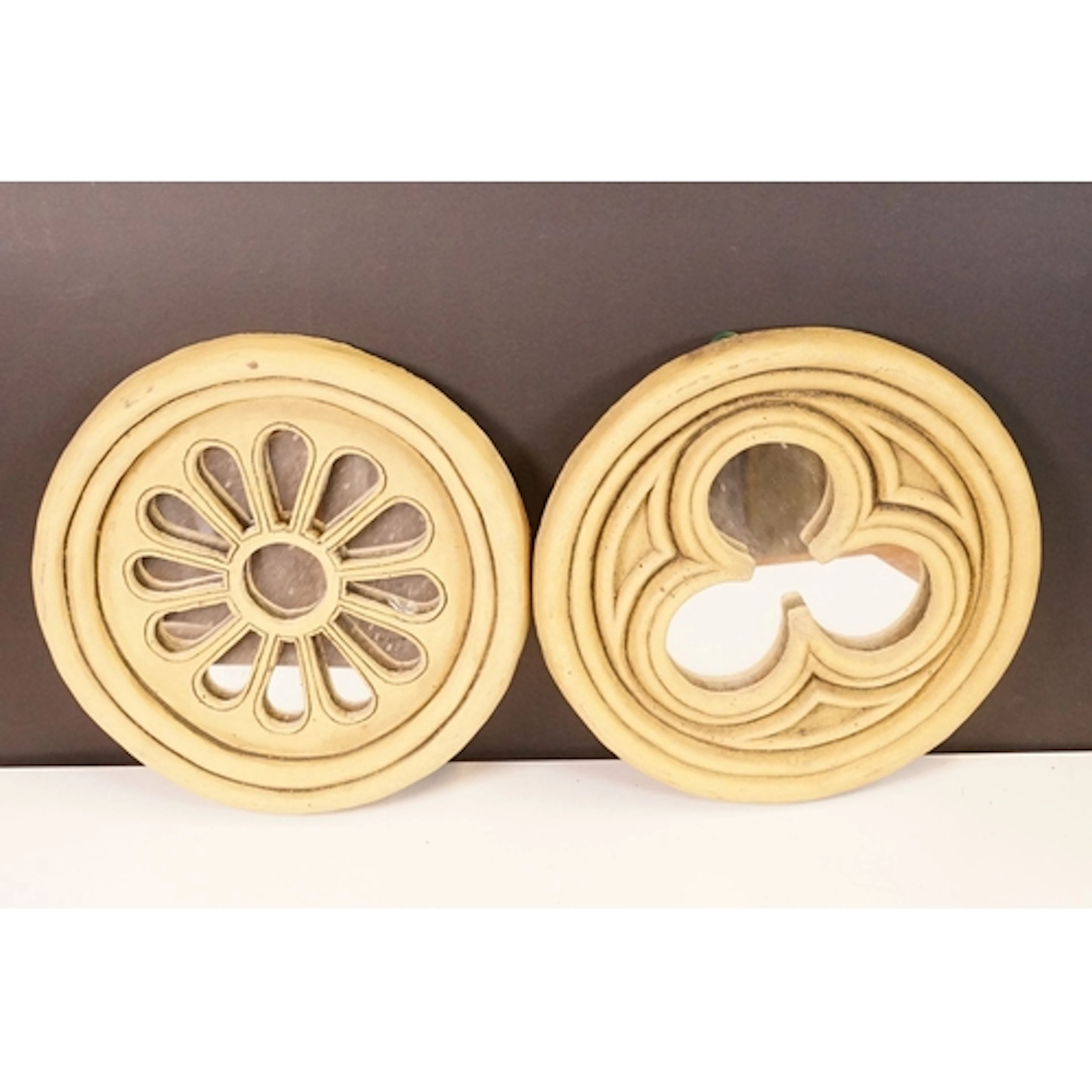Two circular reconstituted stone garden mirrors, one rose an...