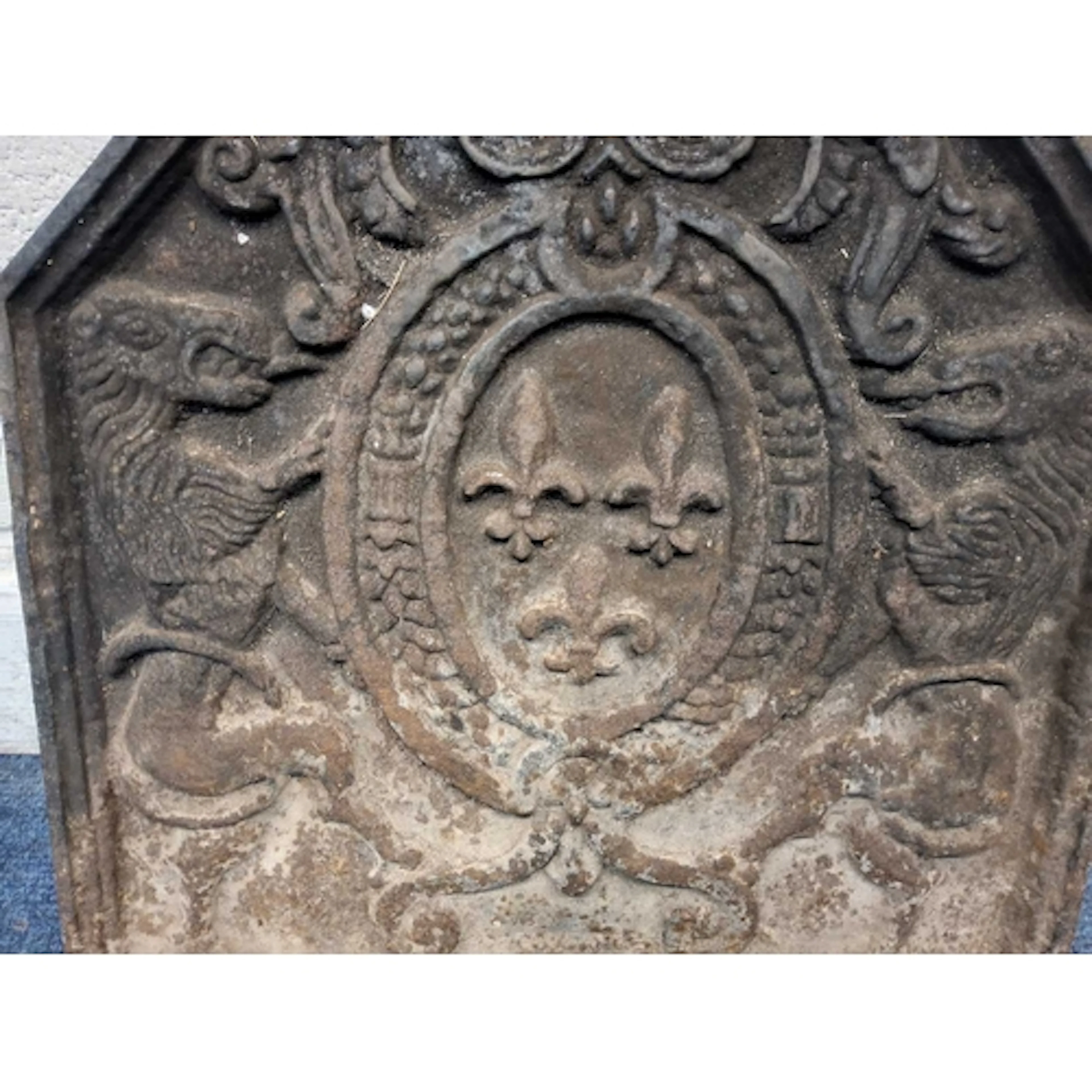 A CAST IRON FIRE BACK, depicting a French coat of arms, with...