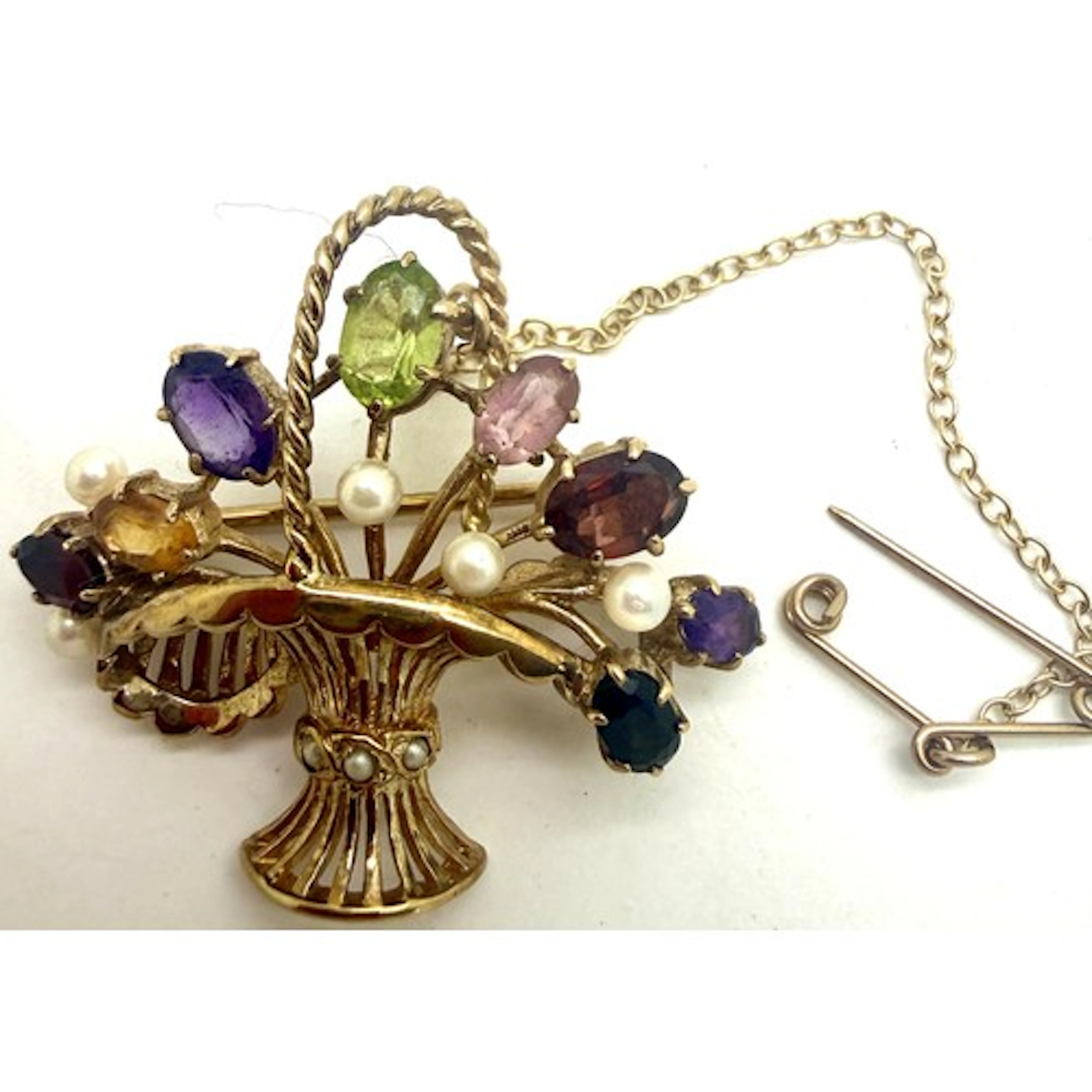 A 9 carat gold brooch in the form of a basket set with multi...