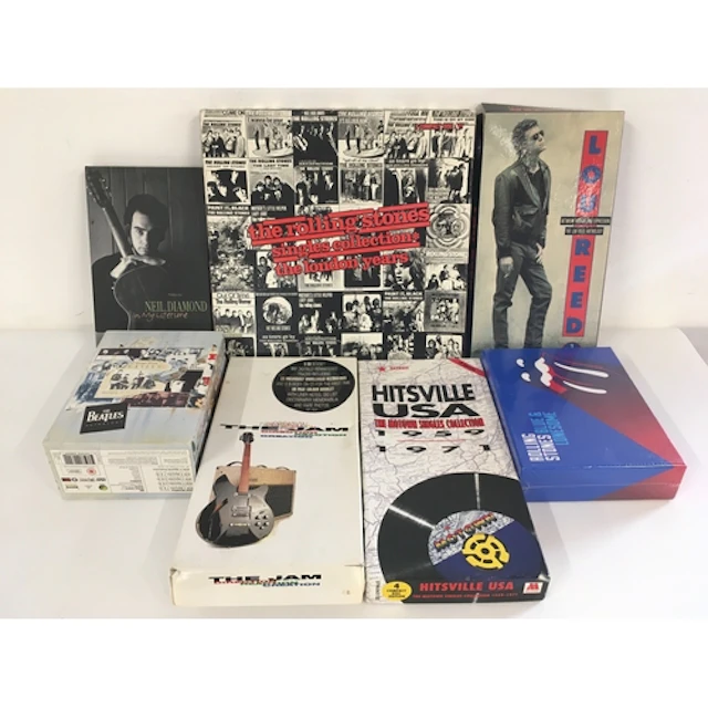 A collection of CD and DVD box sets by various artists inclu...