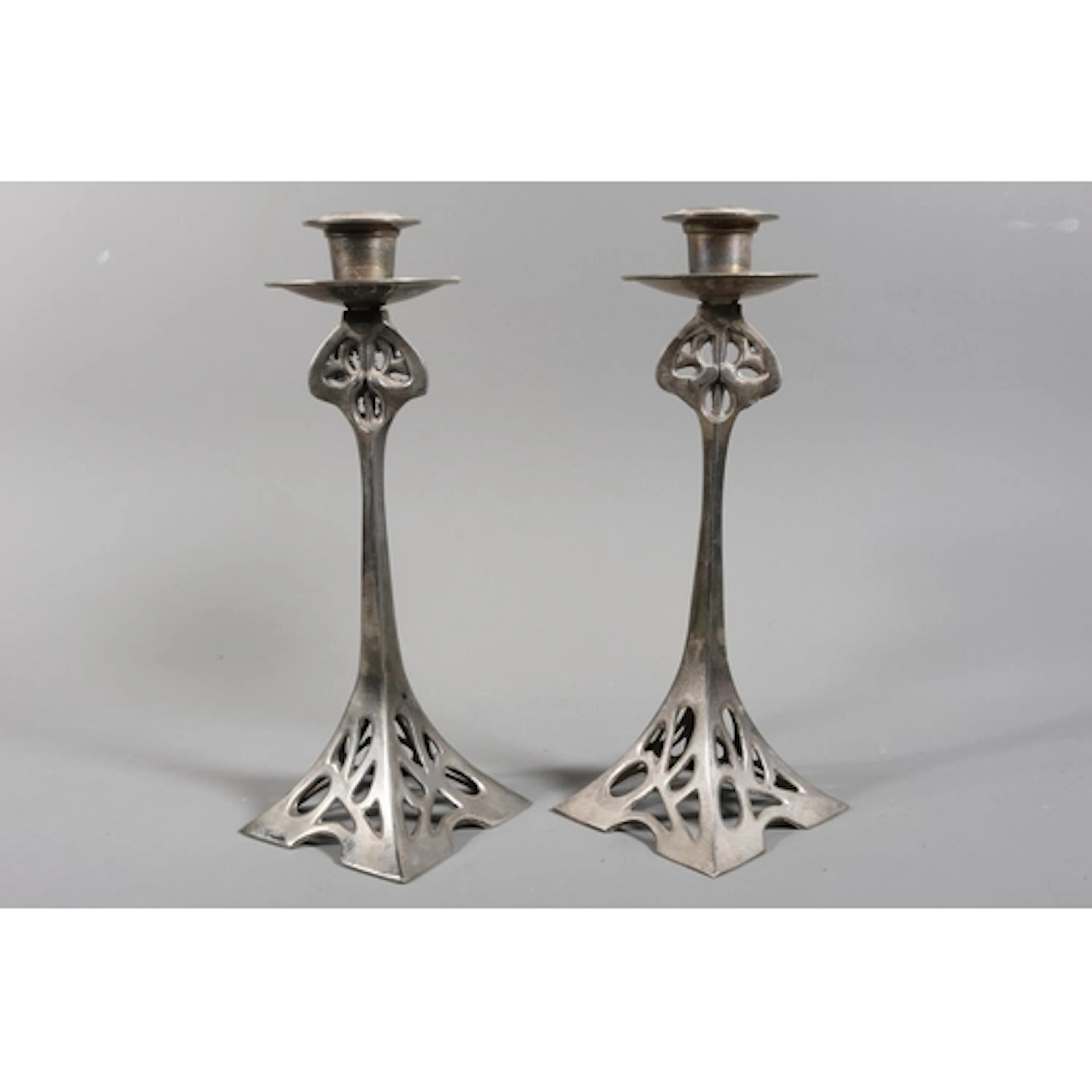 Pair of cast Art Nouveau style candlesticks, each with circu...