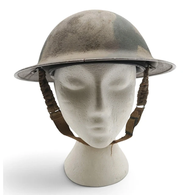 A WW2 British Brodie helmet with applied Malta camouflage, d...