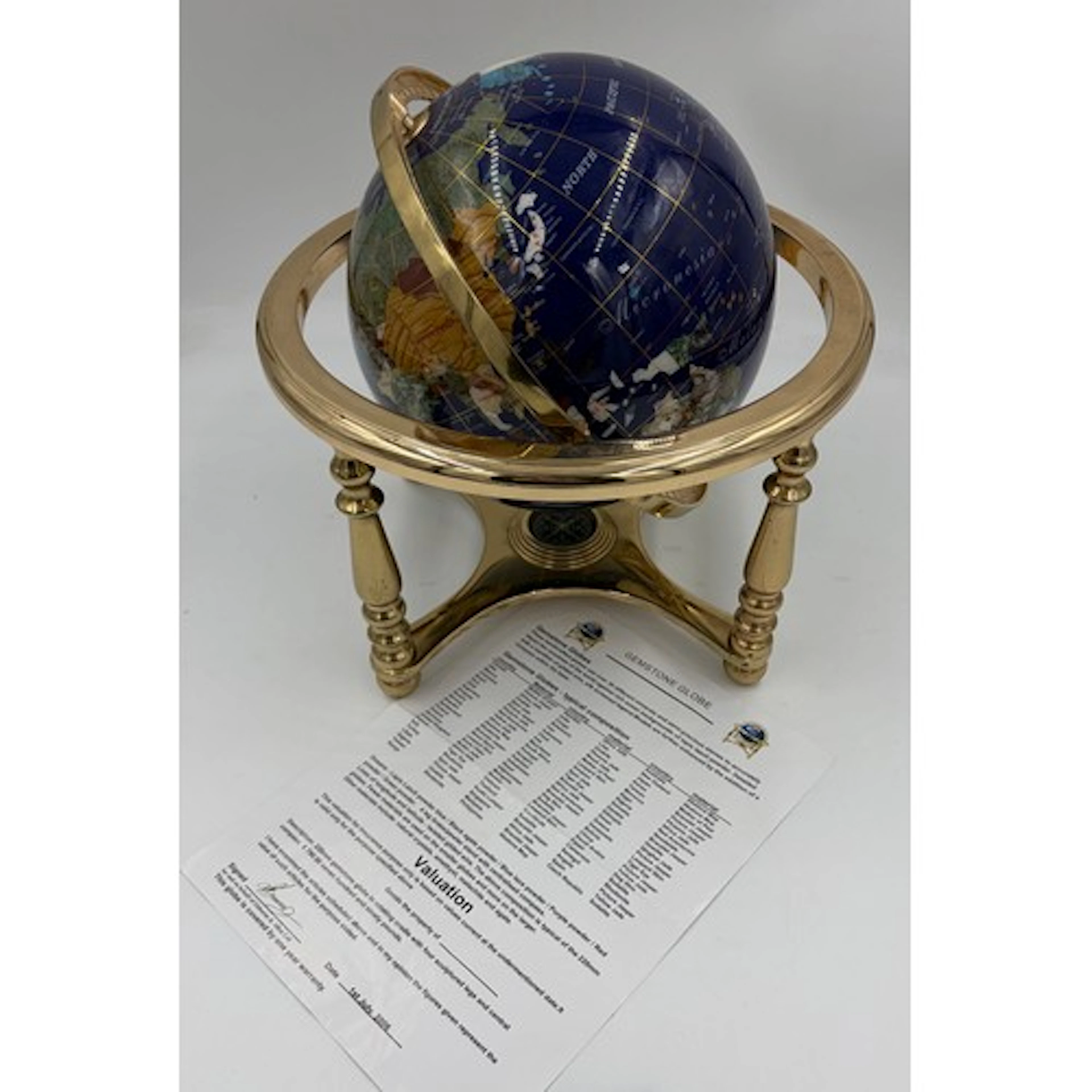 A tabletop Gemstone World Globe in vintage blue lapis backgr...