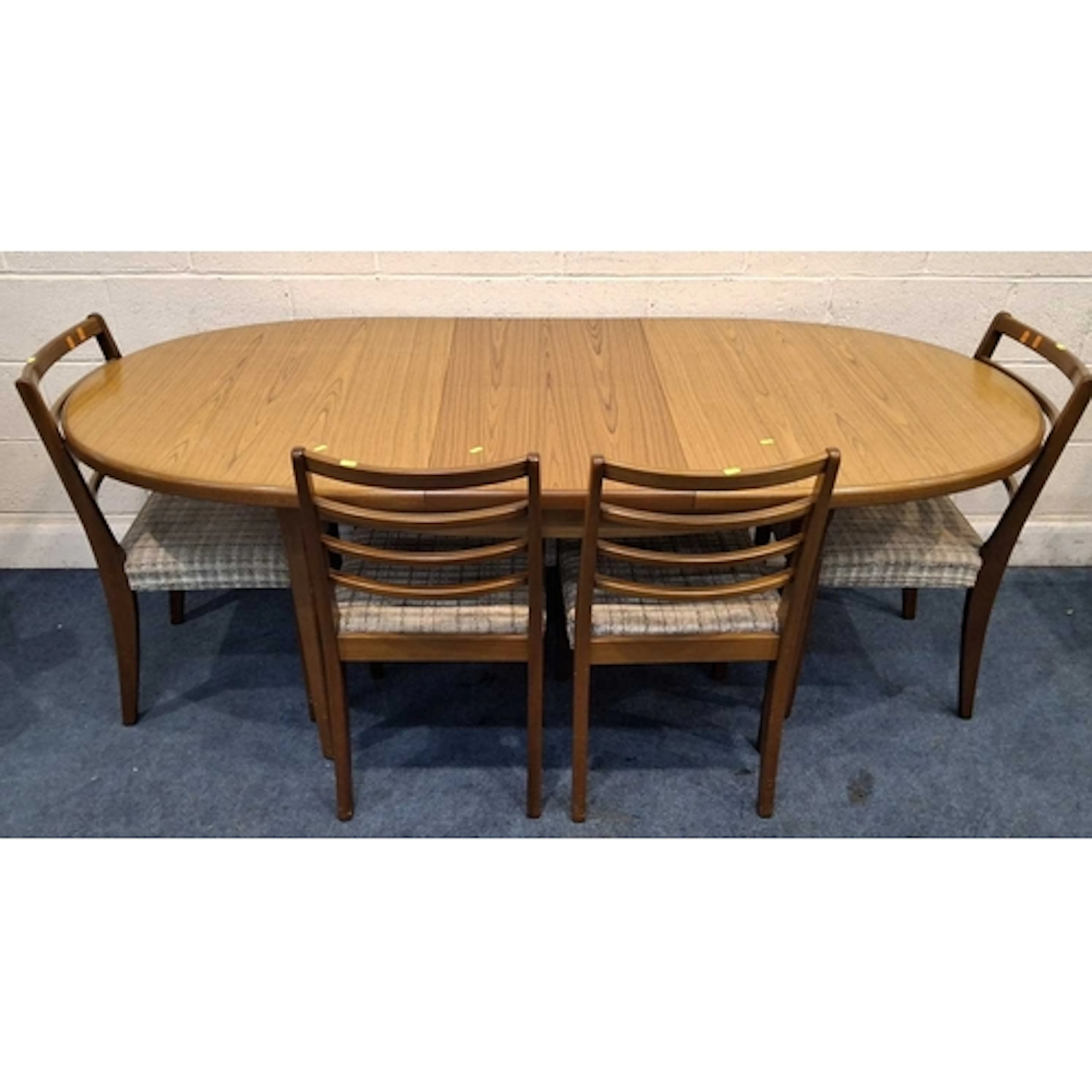 A MID-CENTURY TEAK OVAL EXTENDING DINING TABLE, with a singl...