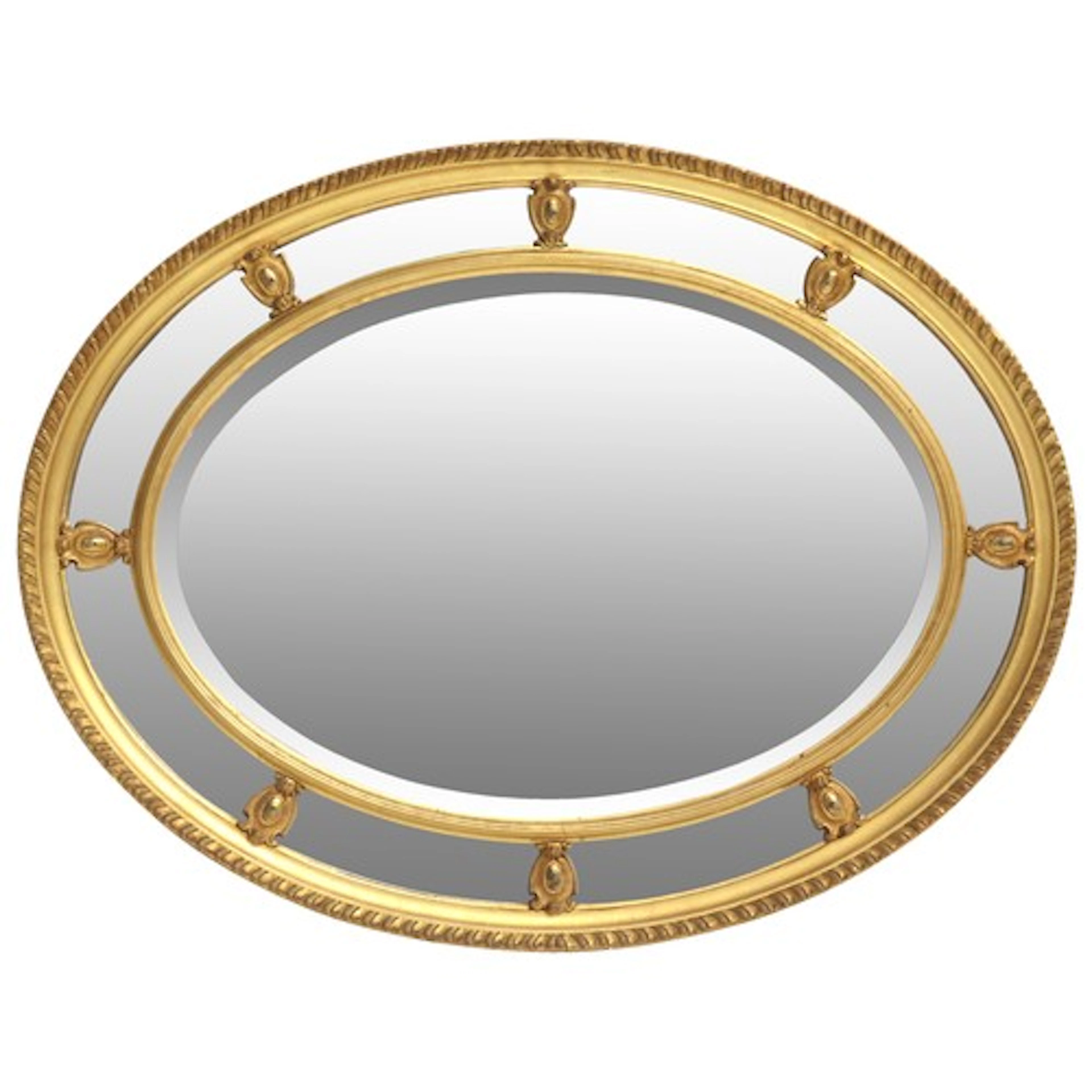 AN OVAL WALL MIRROR with beaded slip 86 x 67 cm Provenance:...