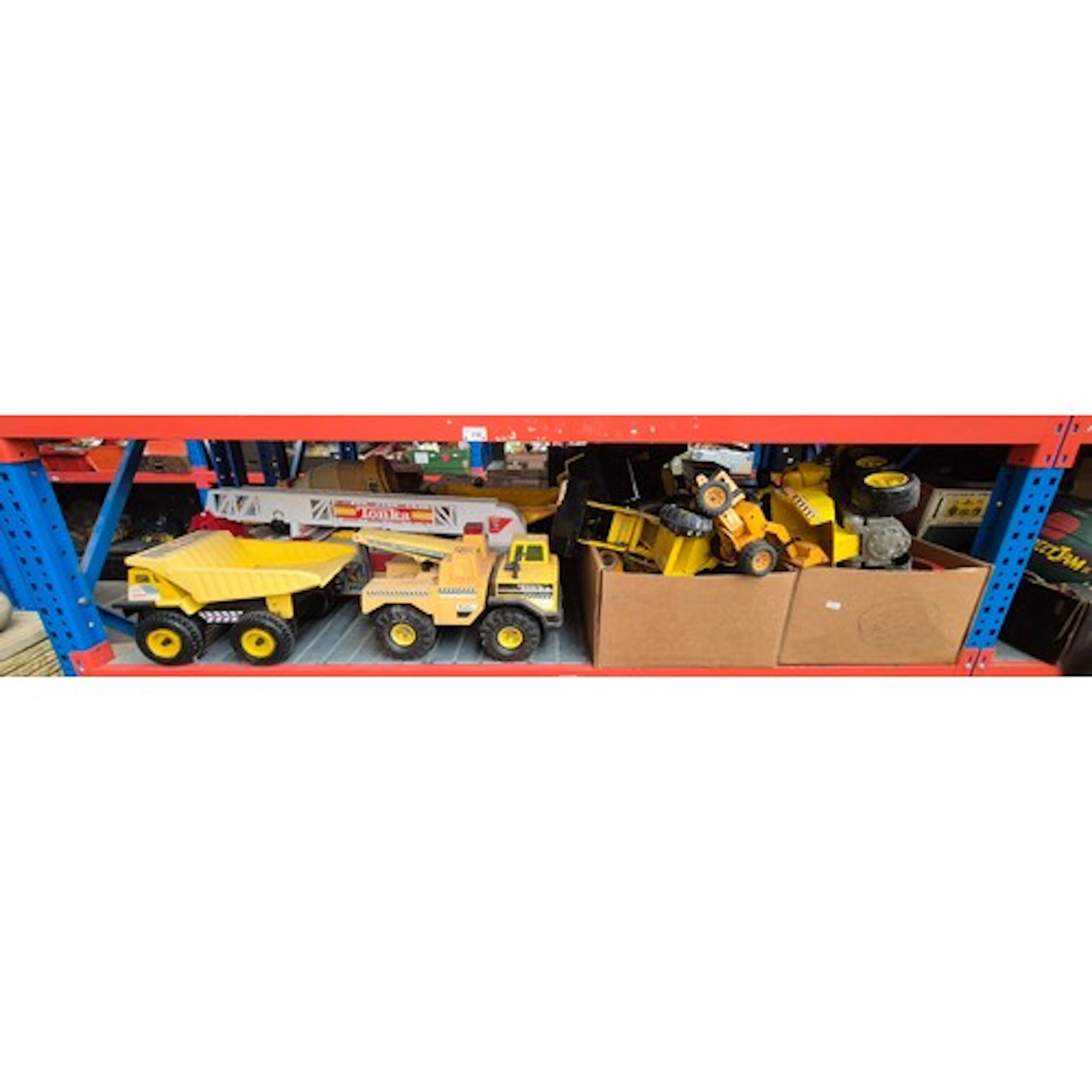 A shelf of play worn Tonka toys