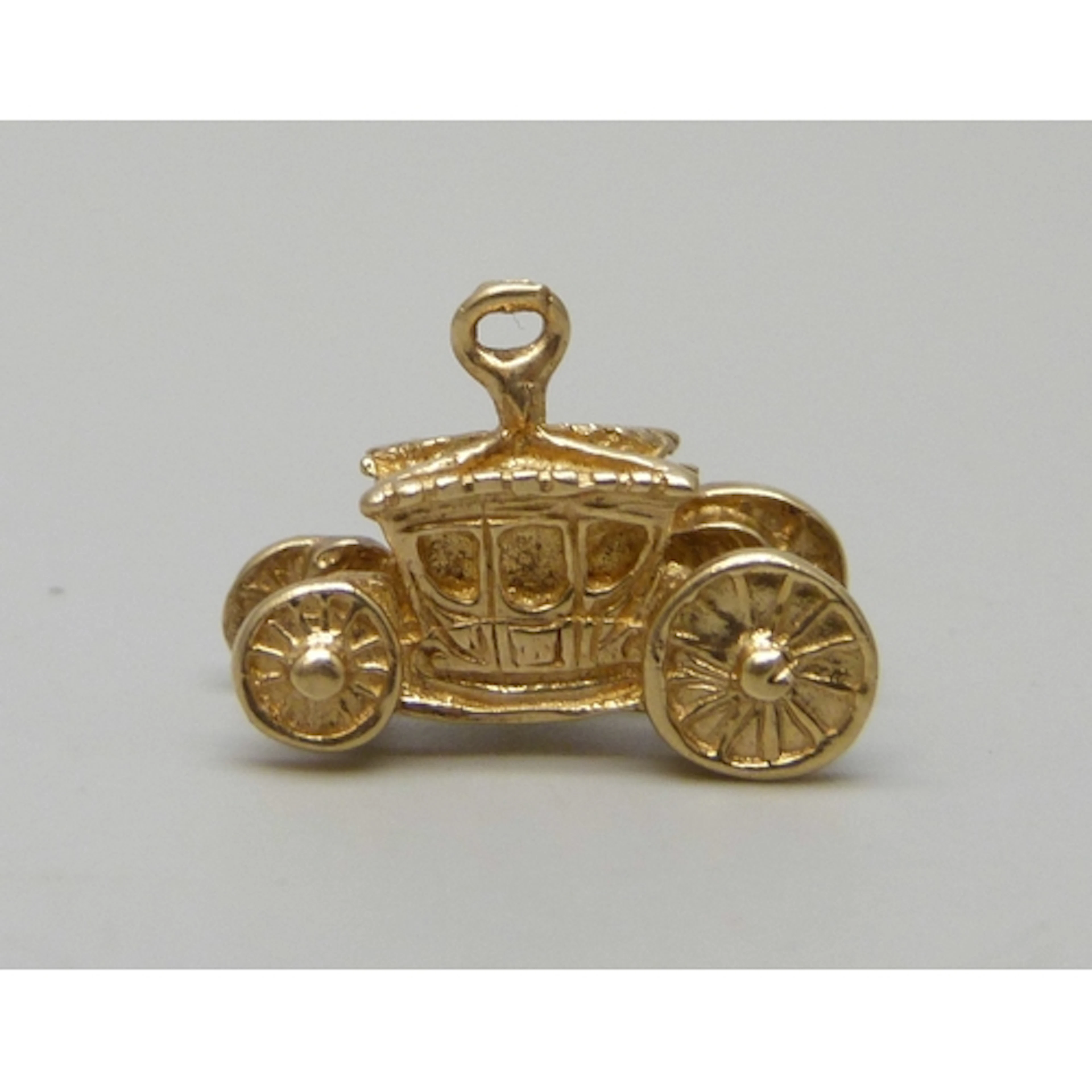 A 14ct gold charm in the form of a Royal carriage, 3.7g, 1.6...