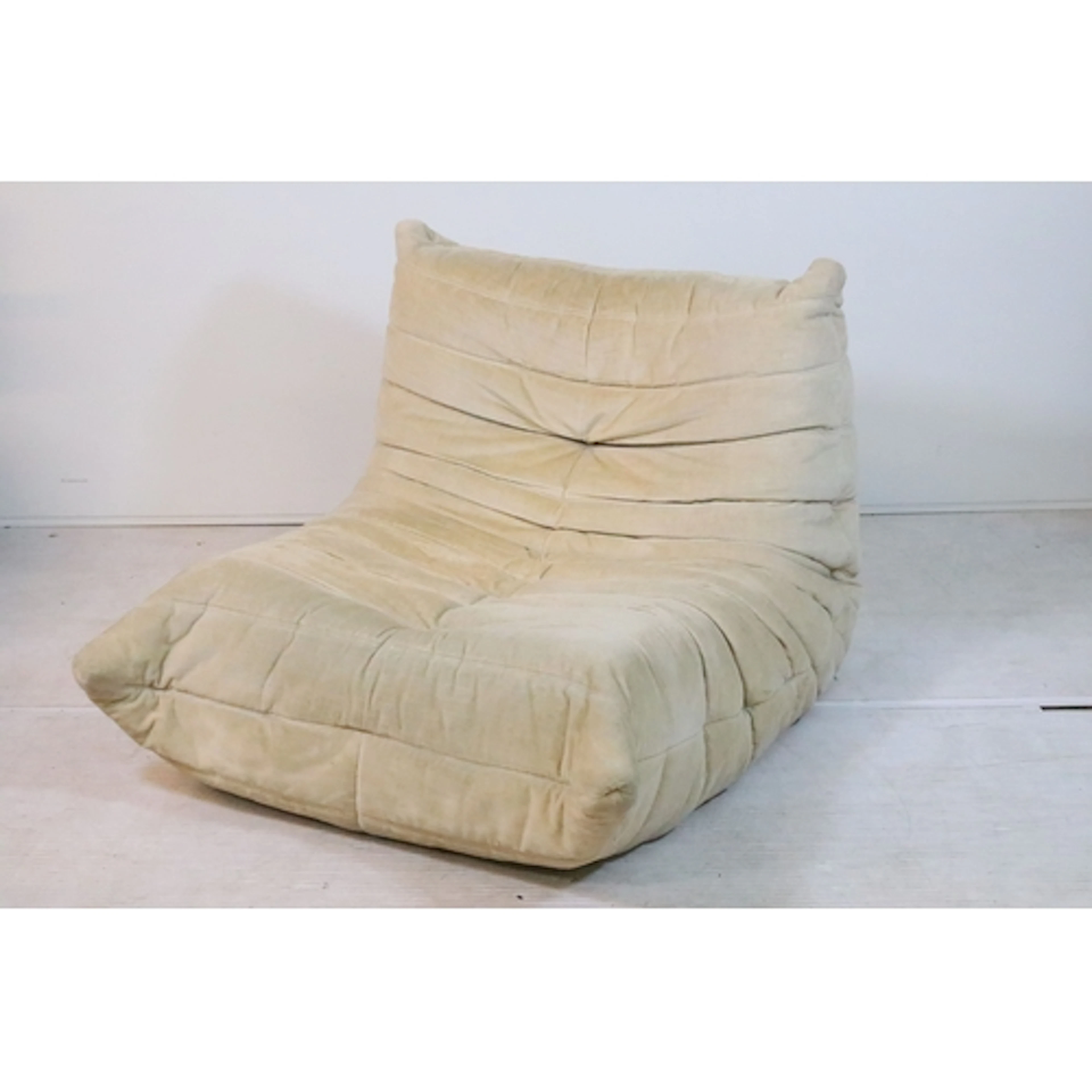 Michel Ducaroy for Ligne Roset; a Togo fireside chair, in cr...