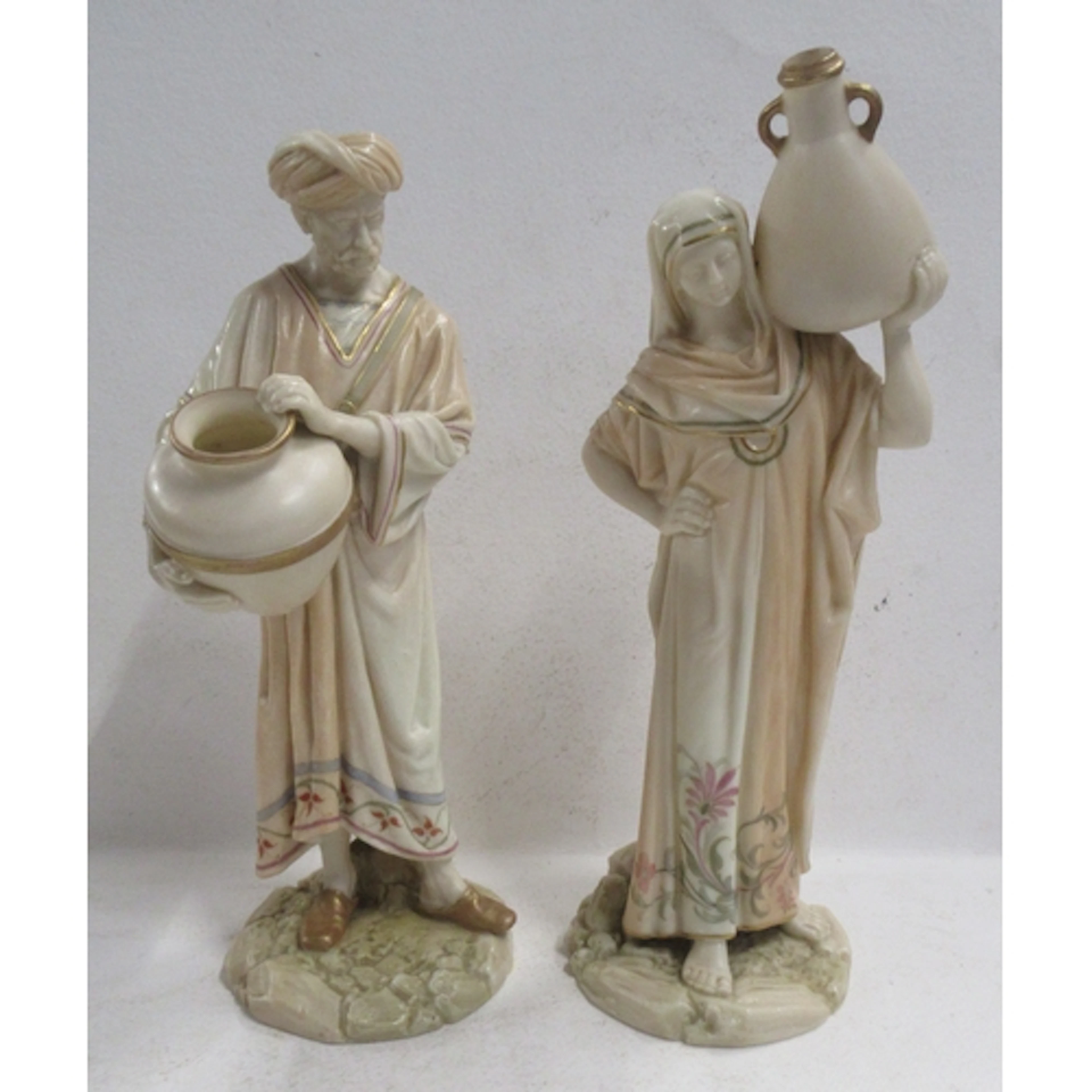 A pair of Royal Worcester blush ivory water carrier figures,...