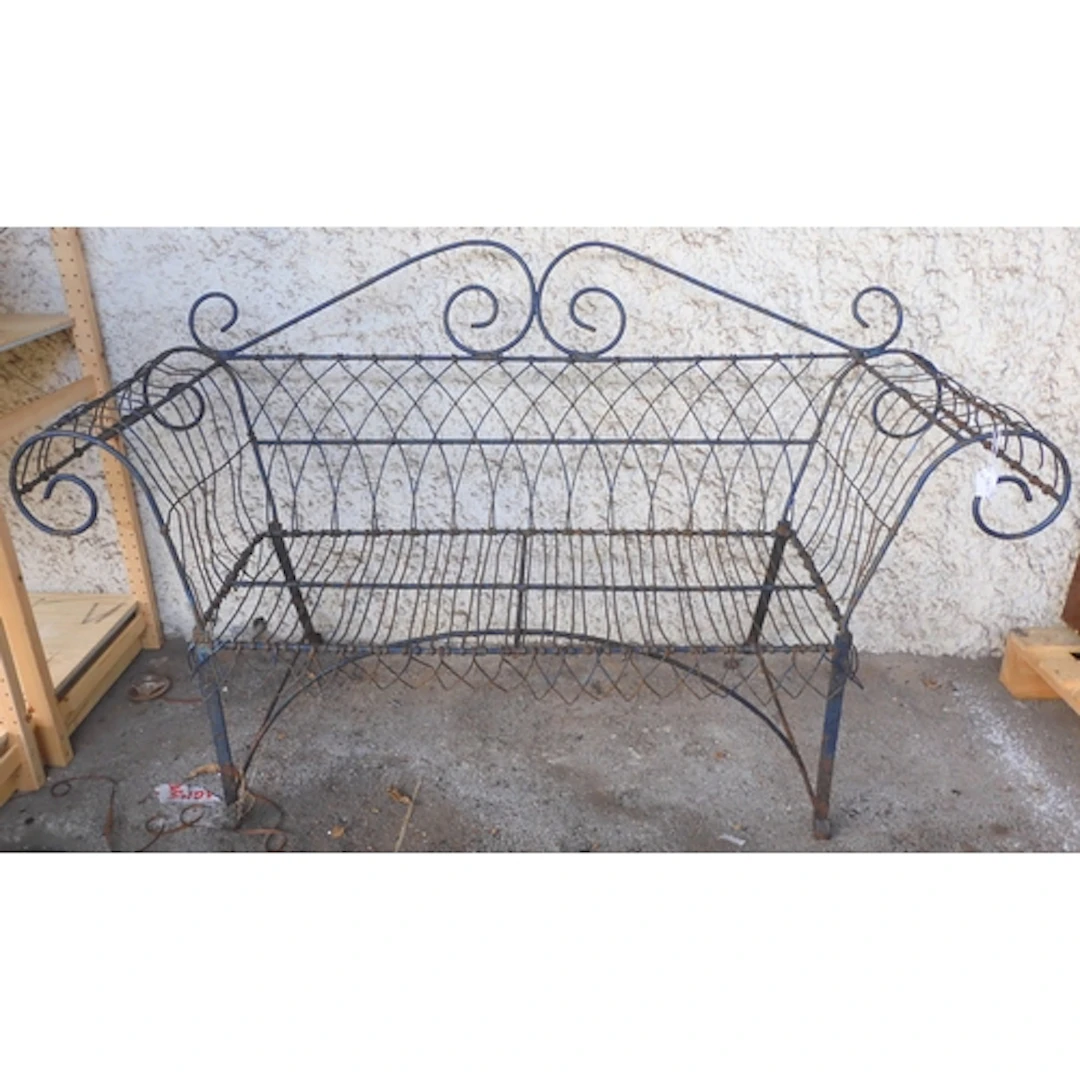 An early 20th century wrought iron wire frame garden bench w...