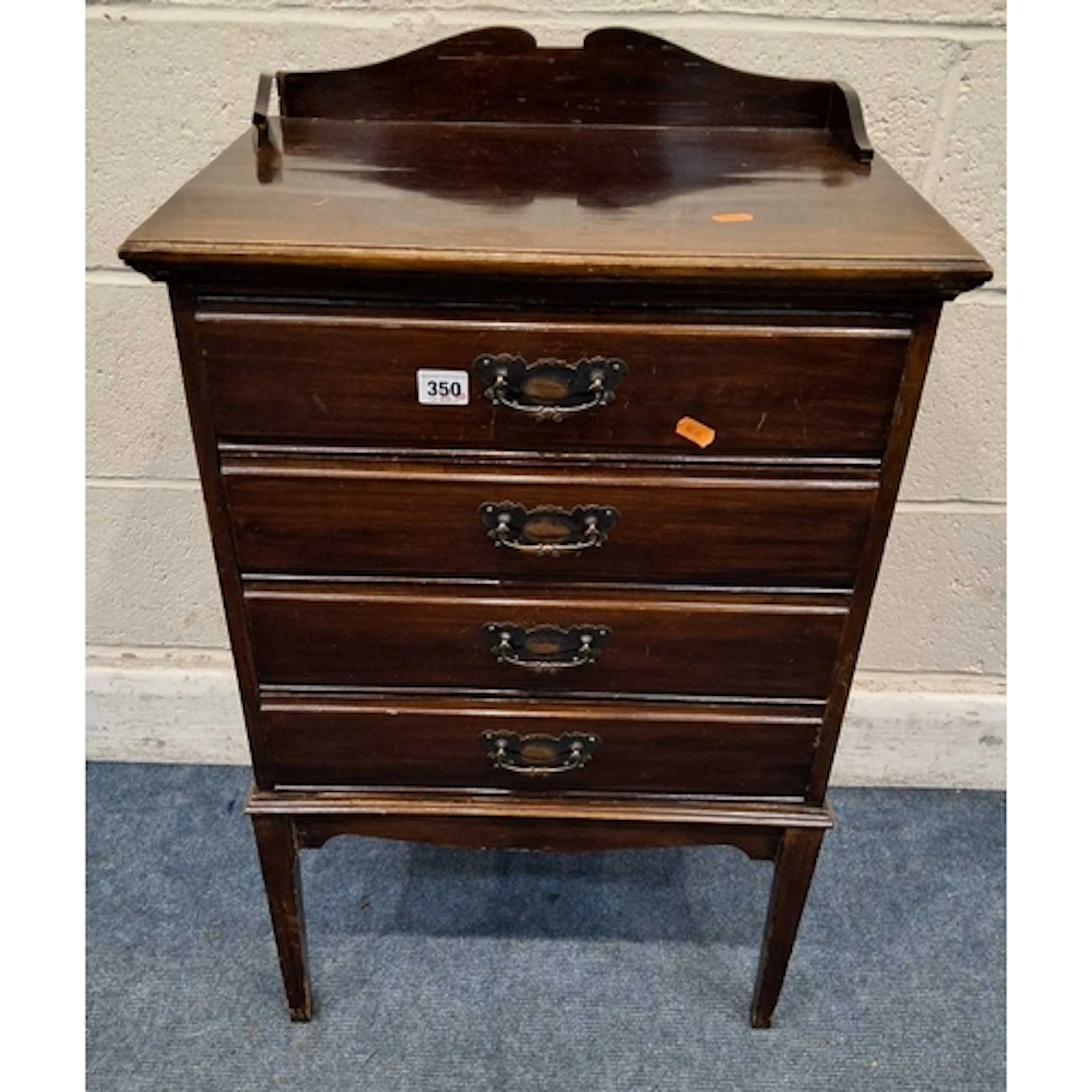 AN EDWARDIAN MAHOGANY MUSIC CABINET, with a raised gallery, ...