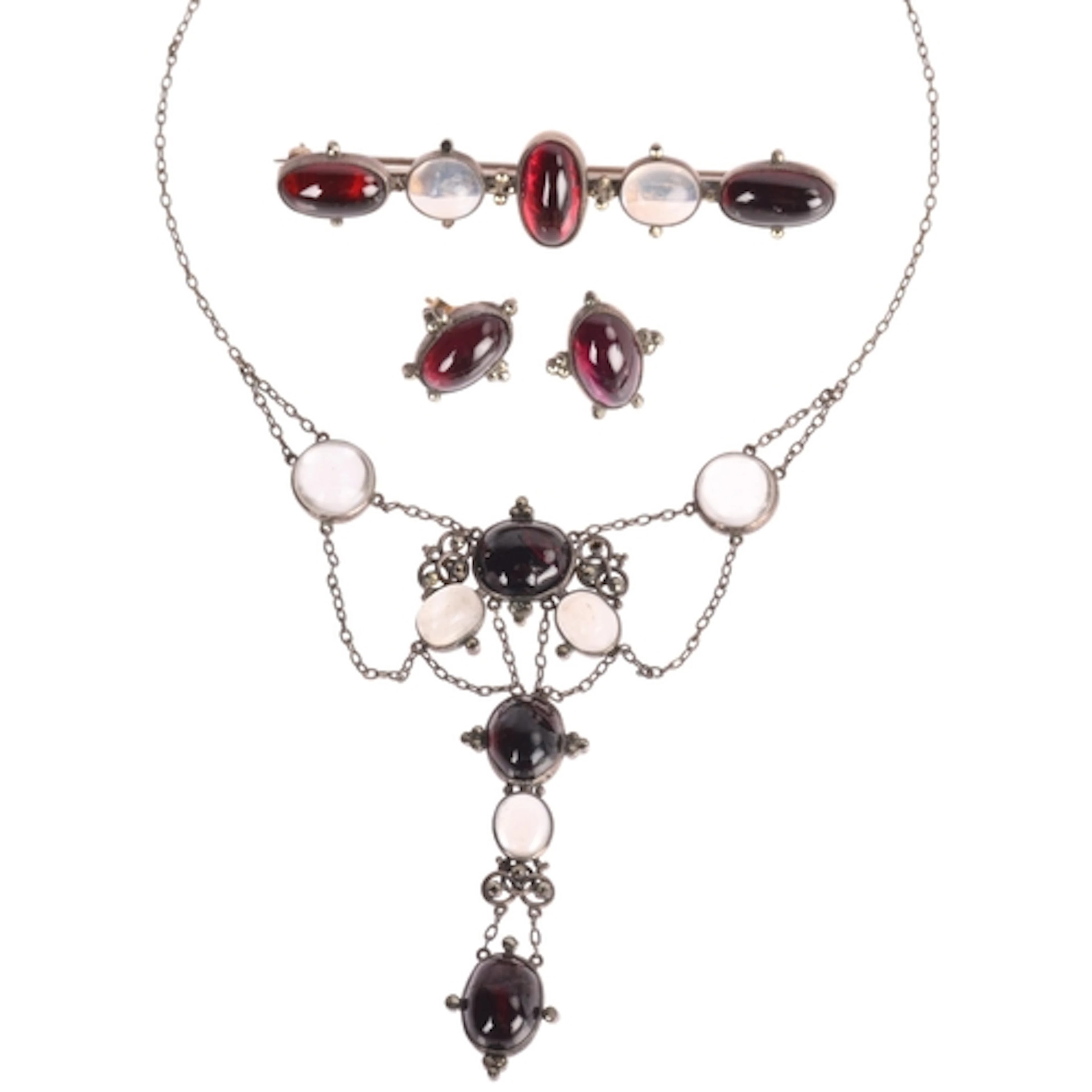An Antique silver garnet and moonstone demi-parure, comprisi...