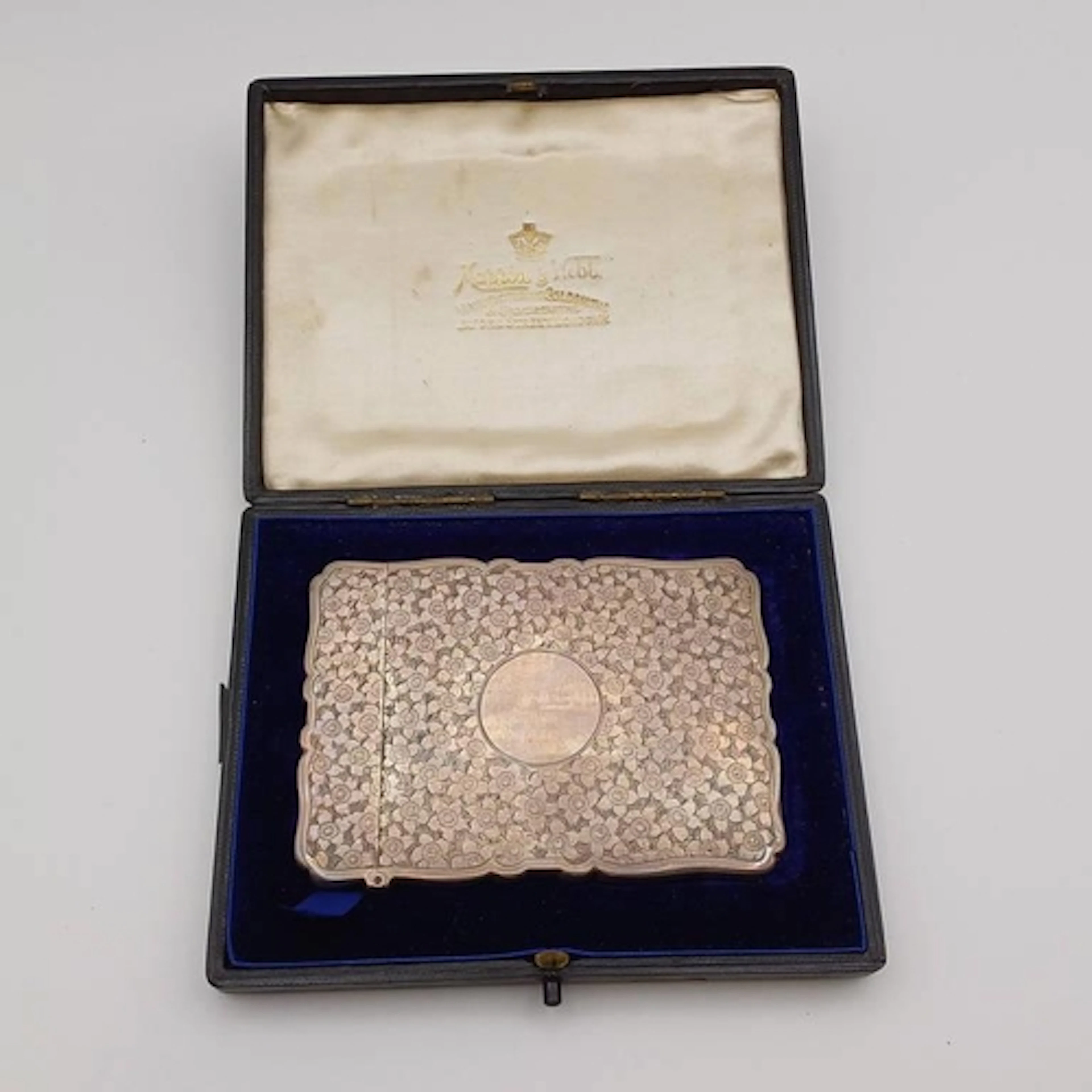 A CASED SILVER CARD CASE WITH ENGRAVED FLORAL DECORATION BY ...