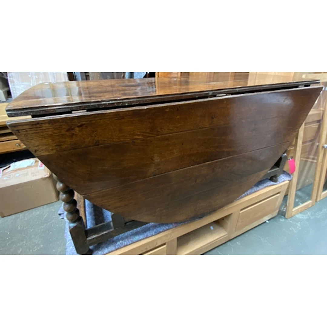 A large oval gateleg table on bobbin turned supports and per...