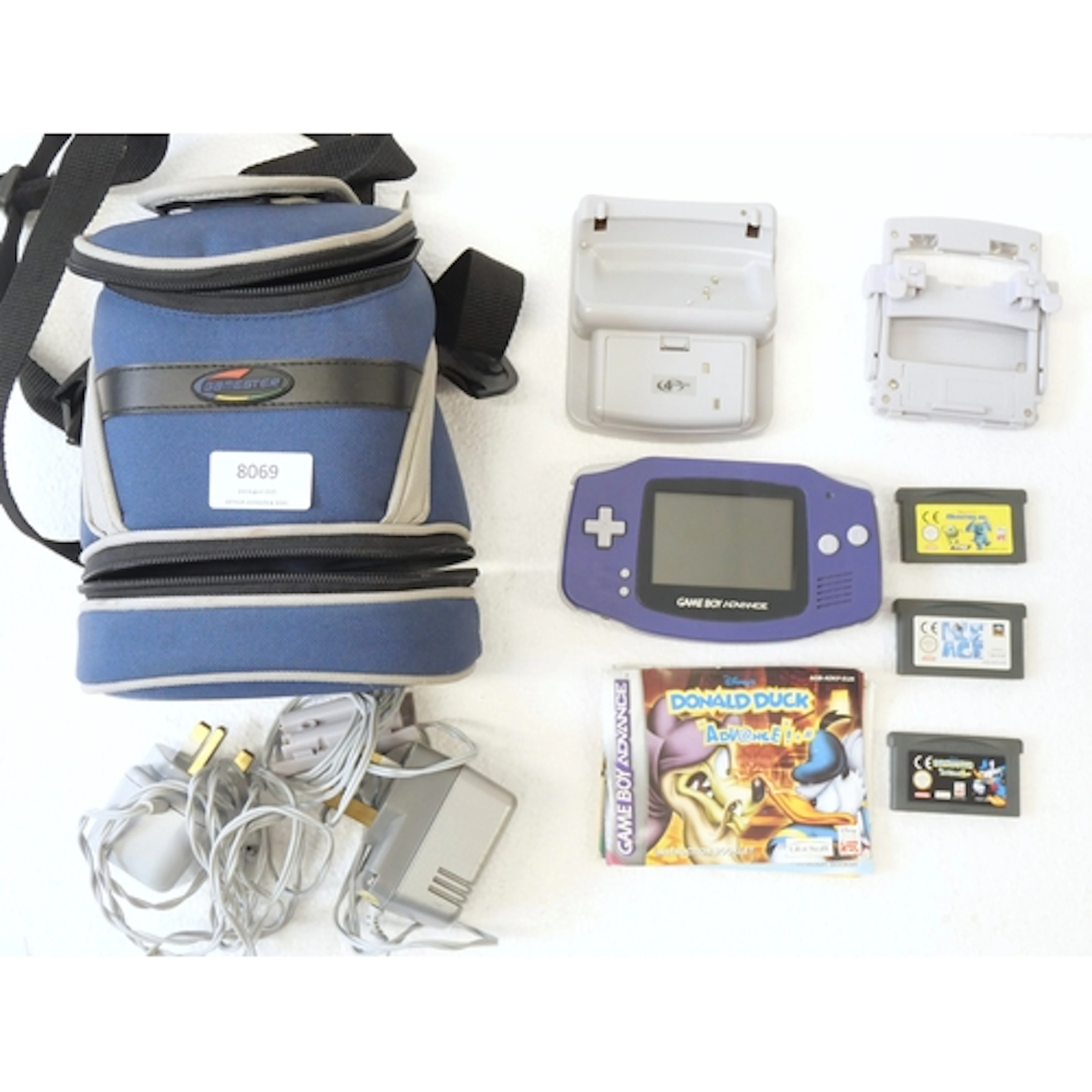A purple Nintendo Game Boy Advance with carry case, a Gamest...
