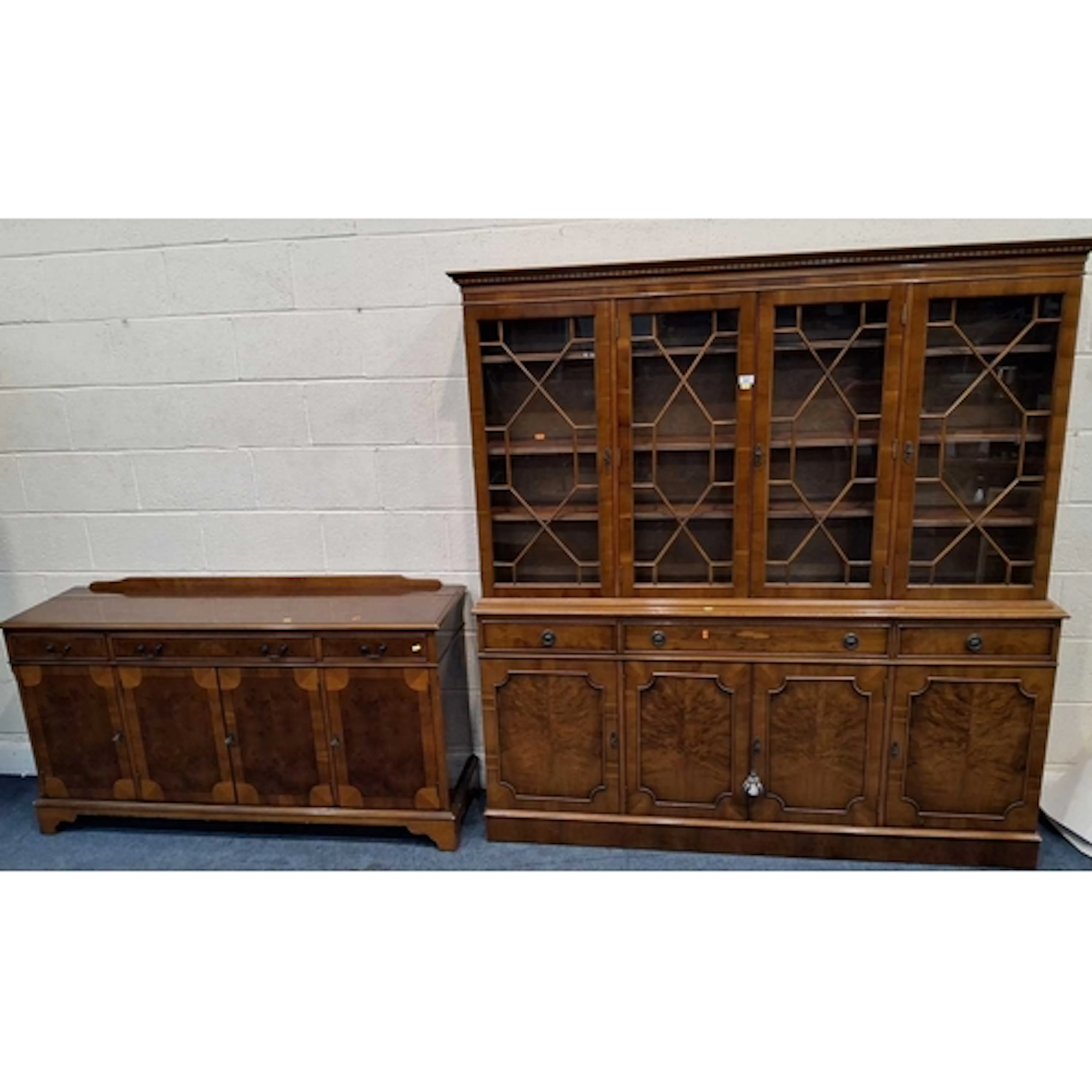 A REPRODUCTION YEW WOOD BOOKCASE, the four glass doors enclo...