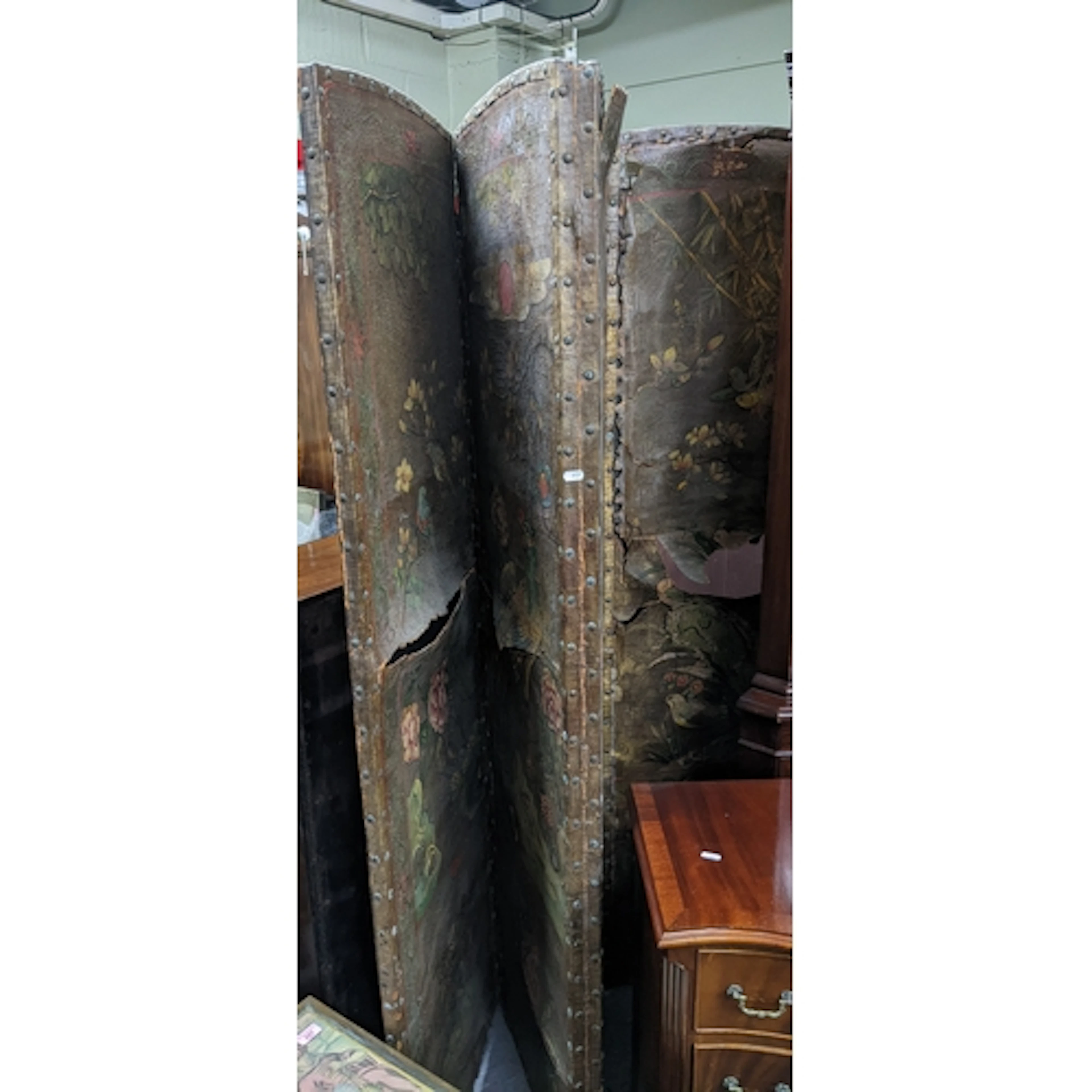 An early 20th century ebonized wood framed four fold screen,...