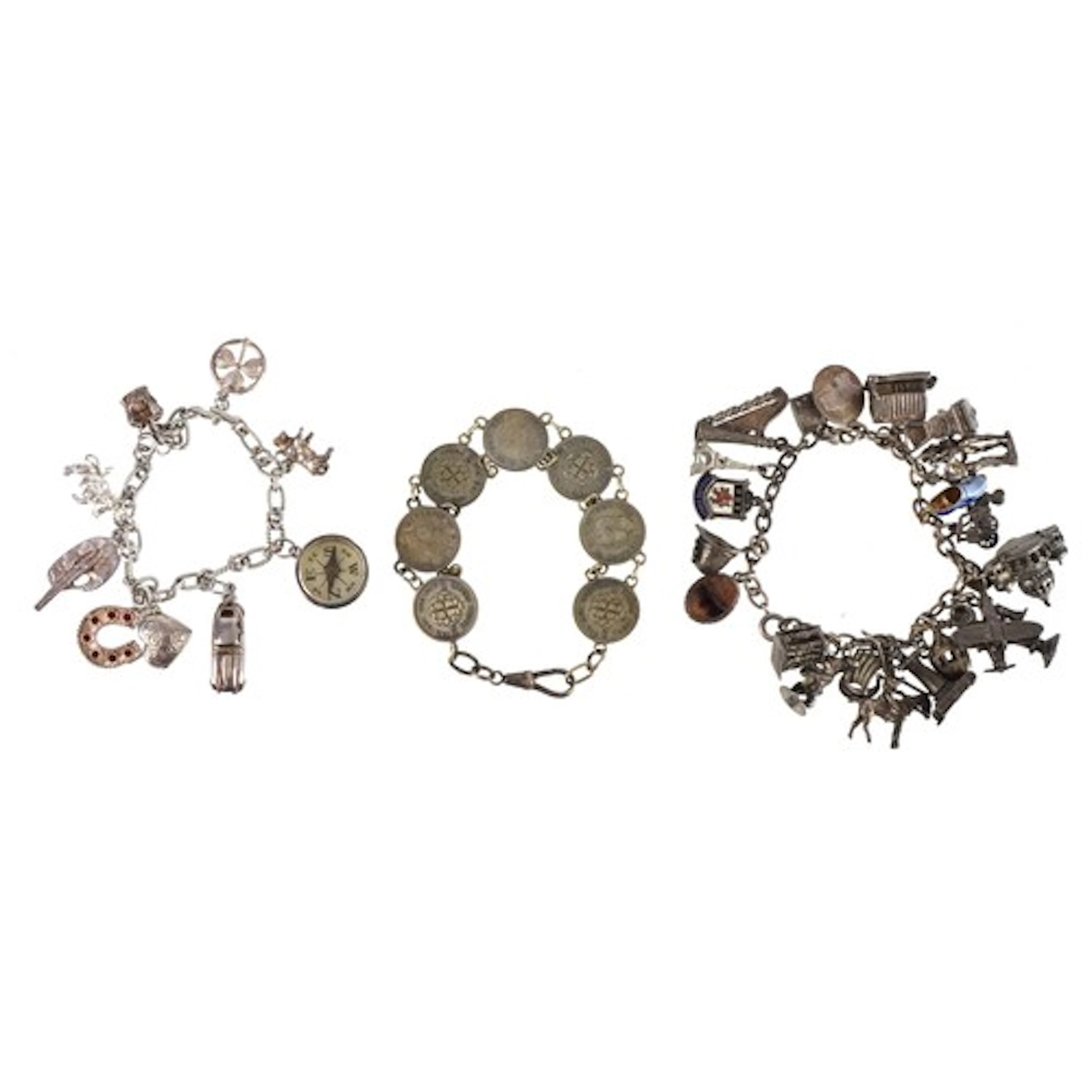 Two silver charm bracelets with mostly silver charms includi...