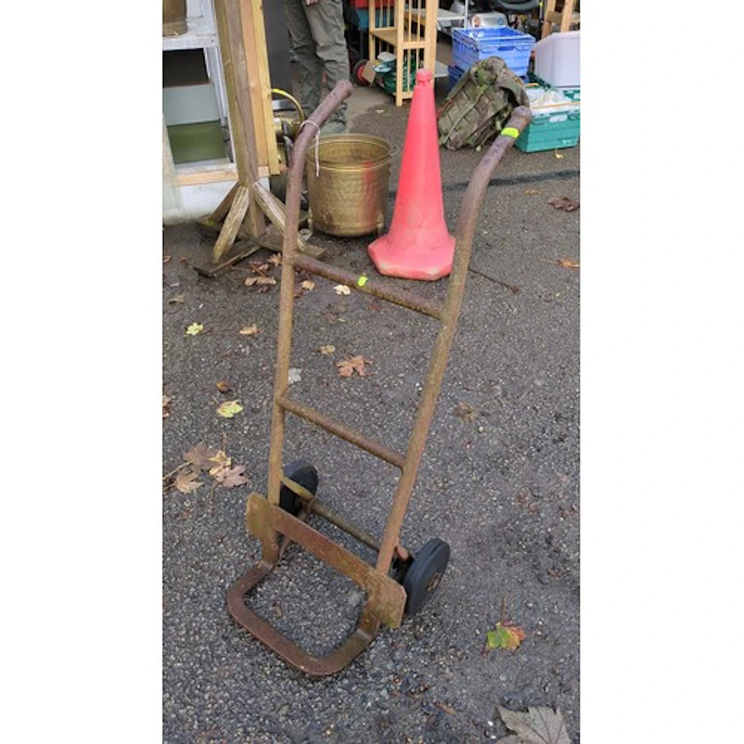 Steel sack truck with a tubular frame, curved handgrips, tra...