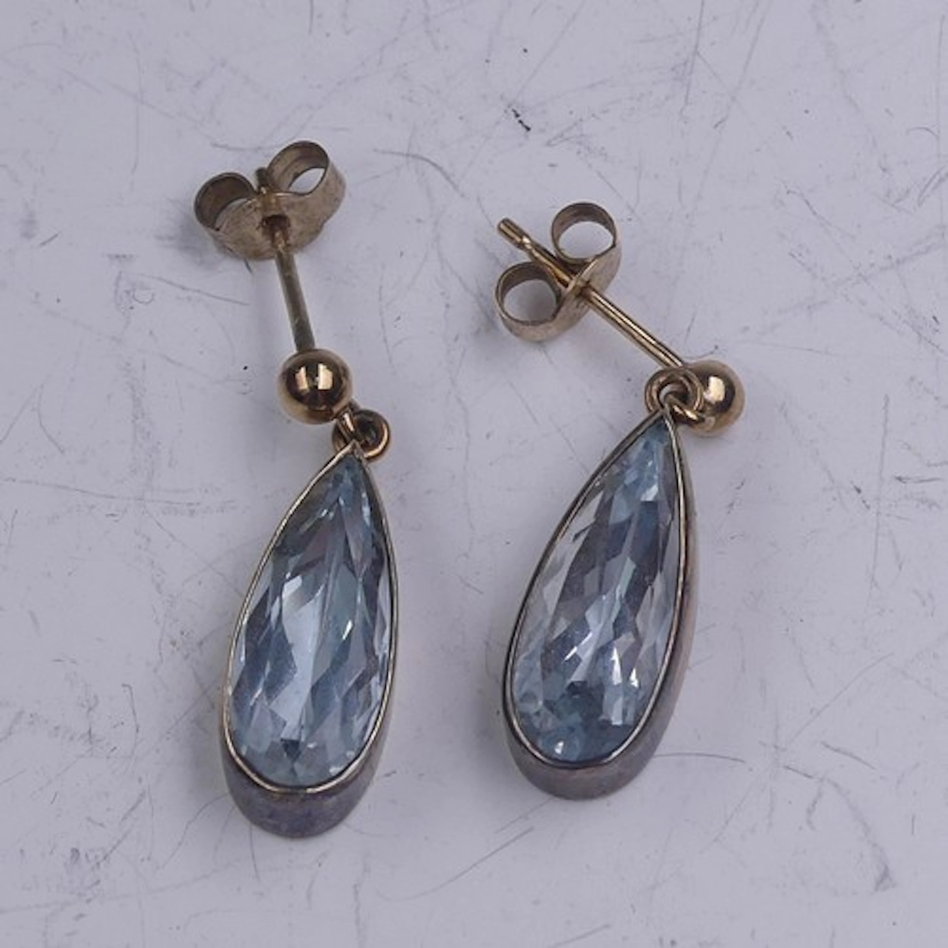 A pair of aquamarine drop Earrings, the facetted pear shaped...