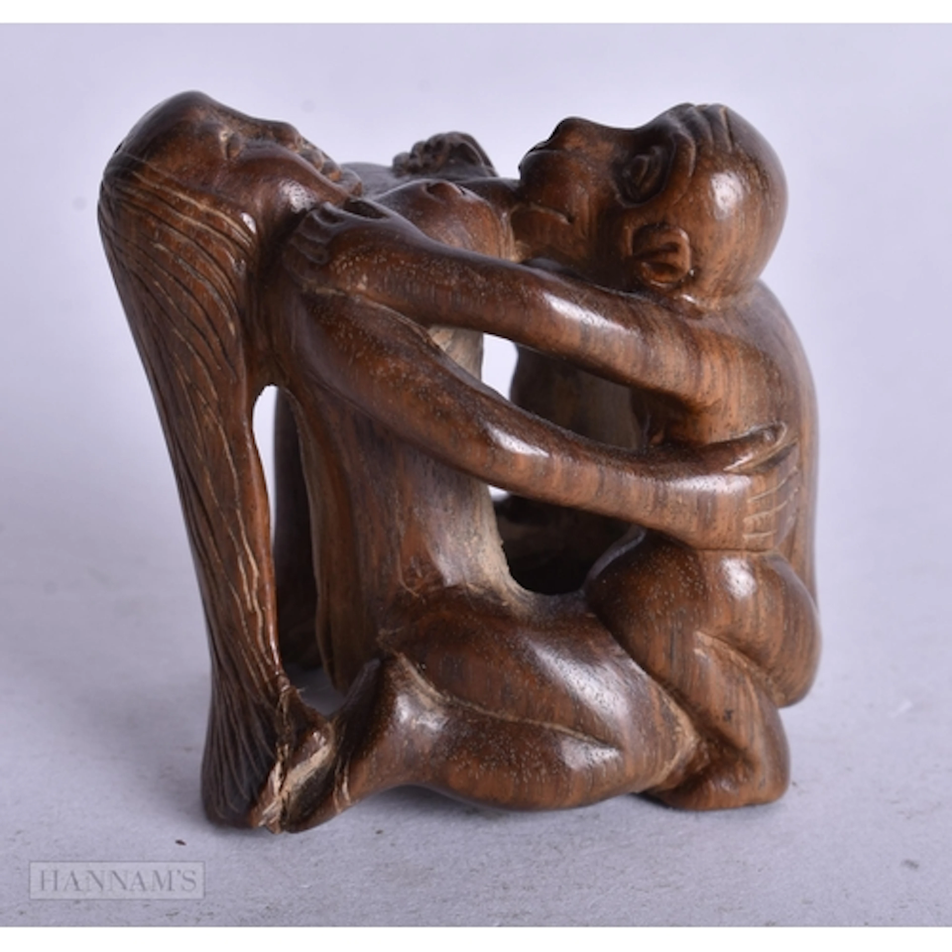 A CARVED WOOD EROTIC NETSUKE. 4.4 x 4.3 x 3 cm