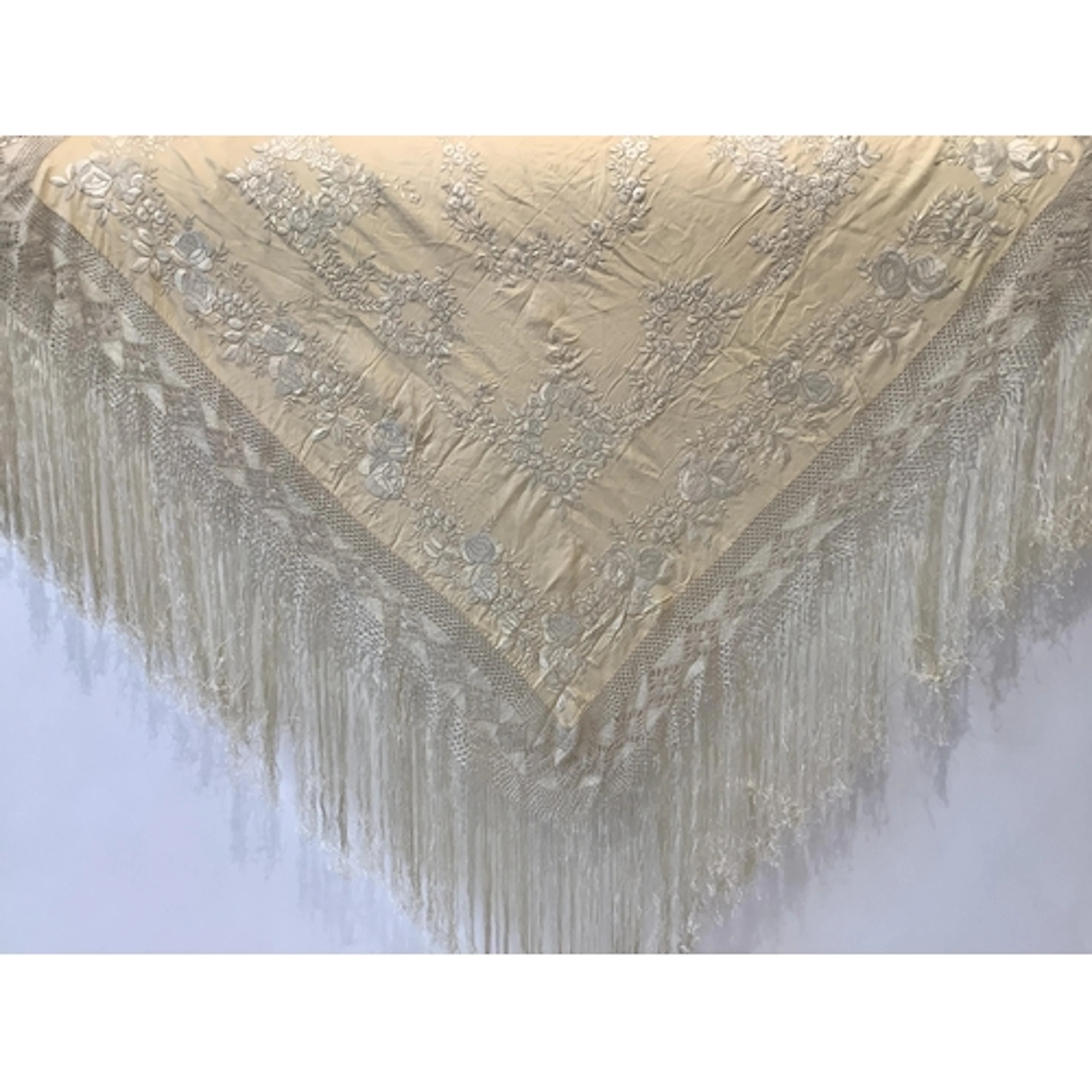 A Chinese cream silk shawl, with white silk floral embroider...