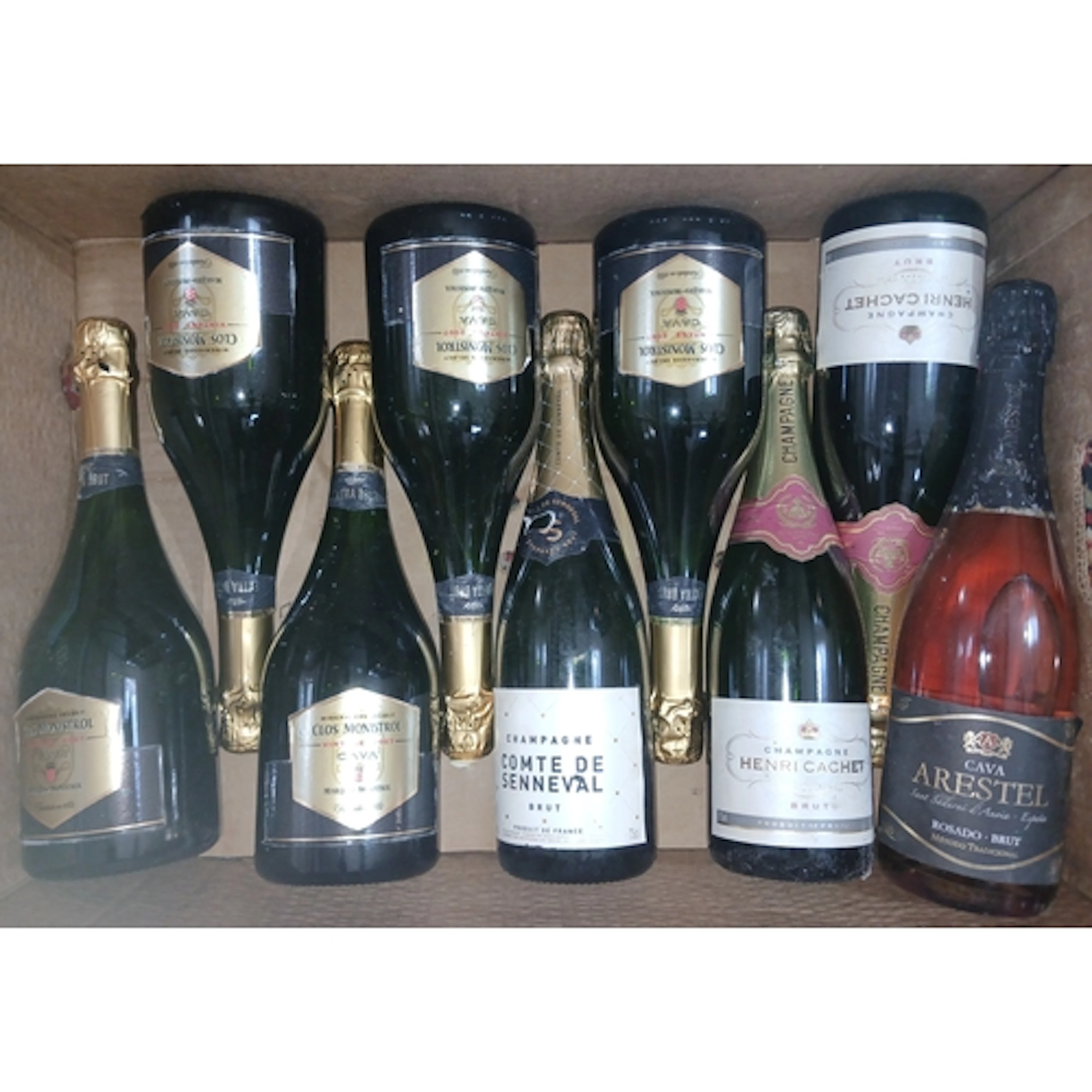Nine bottles of assorted sparkling wine.