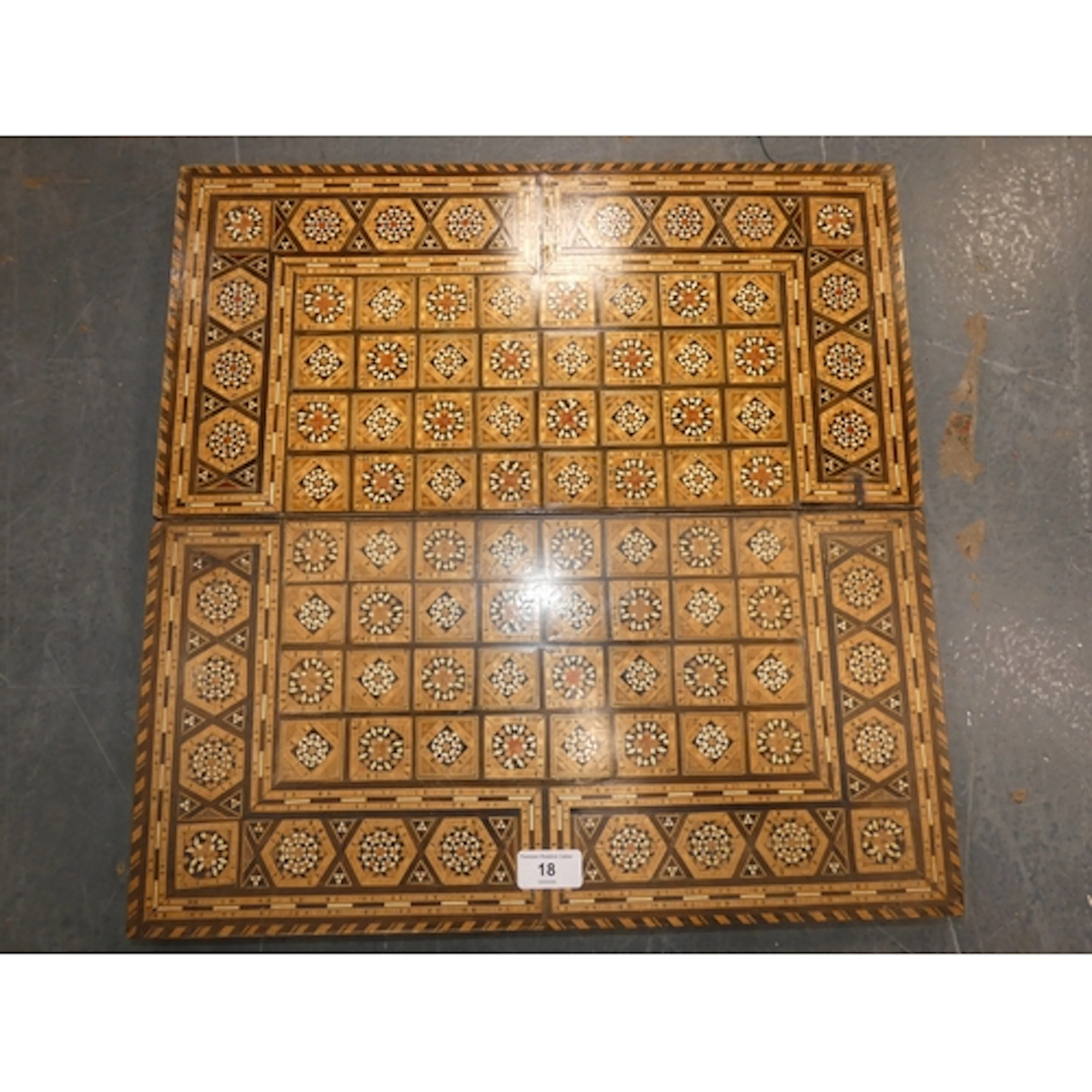 Antique marquetry games board with backgammon interior.