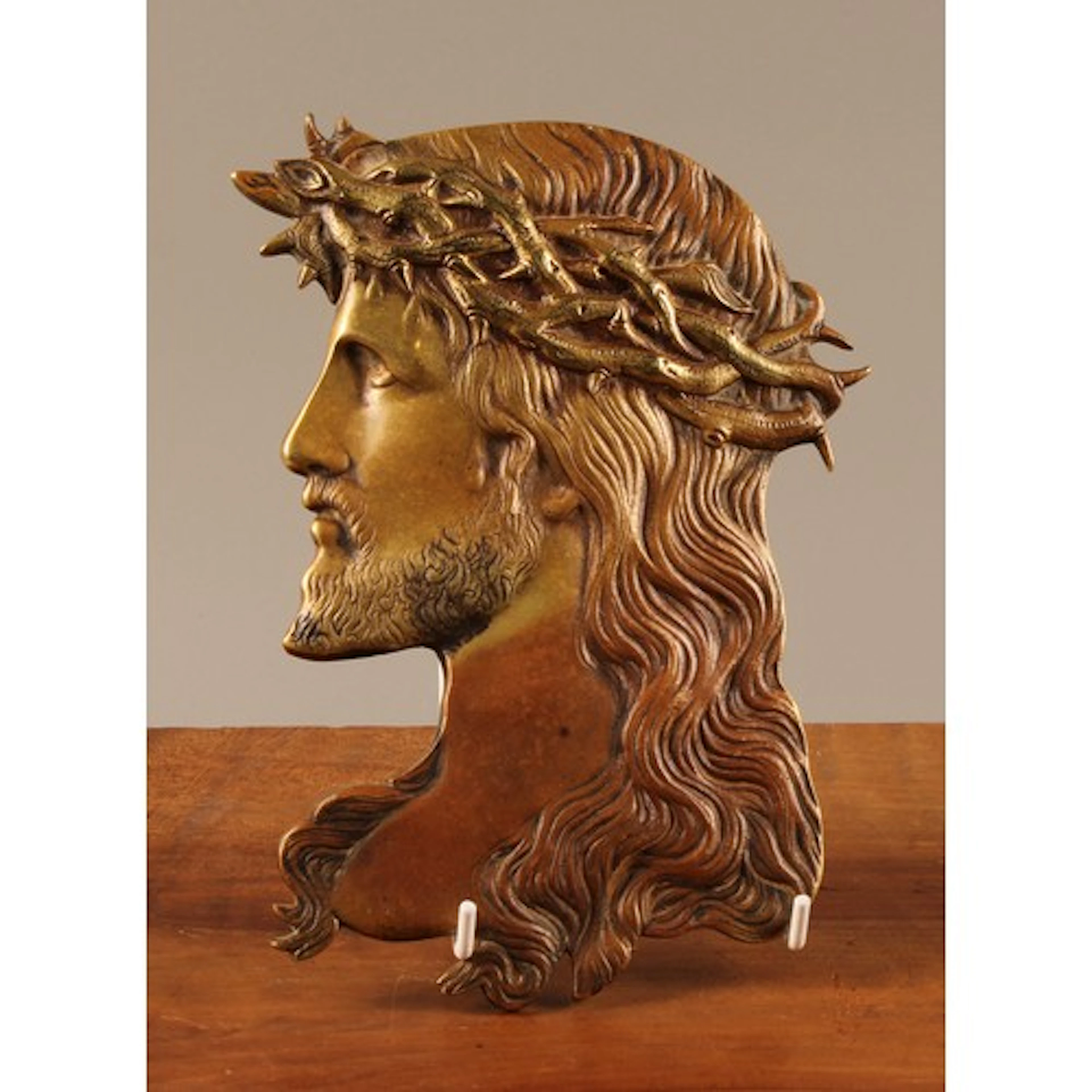 An Art Nouveau period brass wall hanging plaque, profile bus...