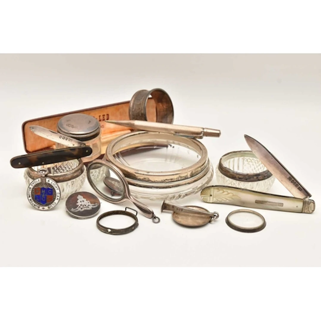 AN ASSORTMENT OF SILVER ITEMS, to include three silver rimme...