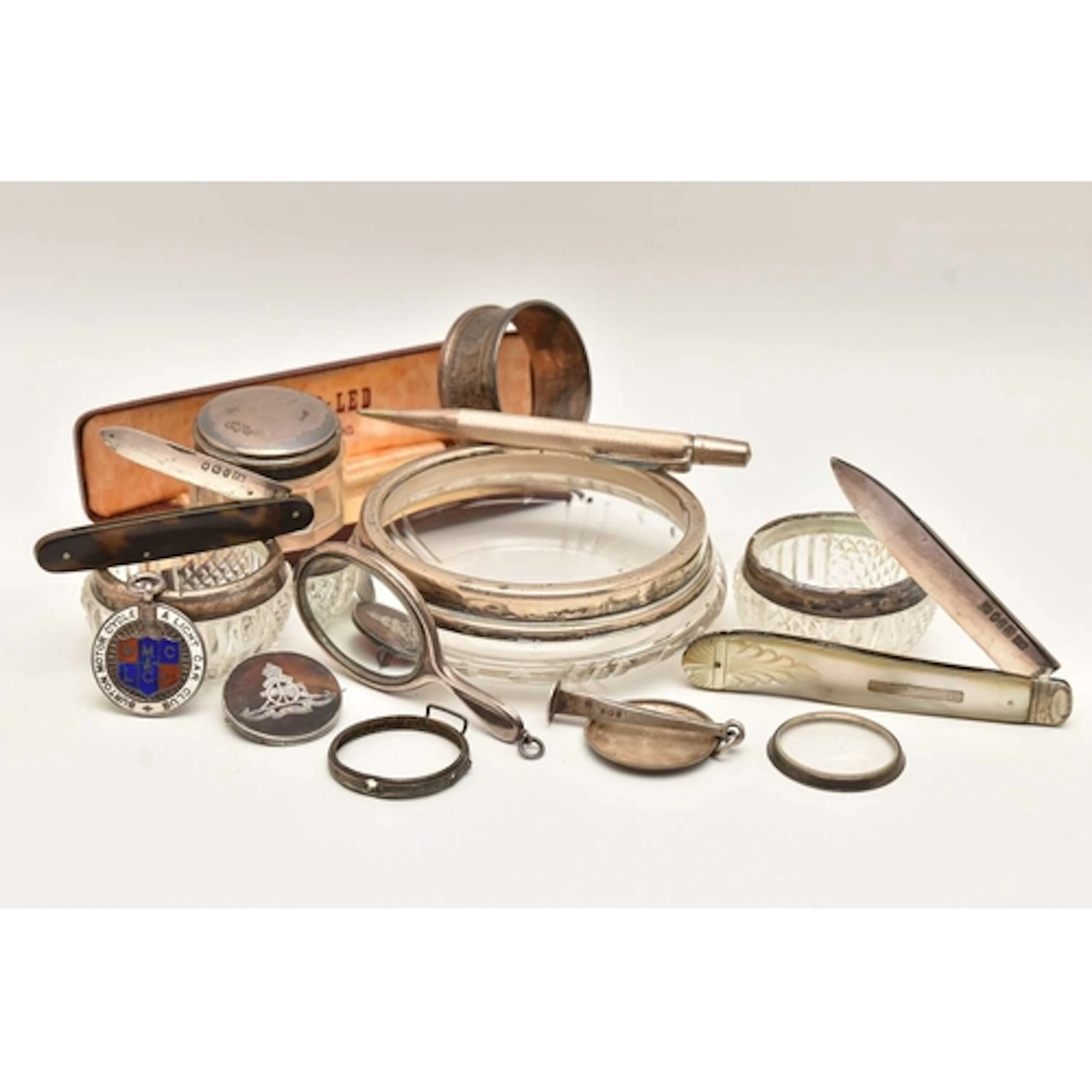 AN ASSORTMENT OF SILVER ITEMS, to include three silver rimme...