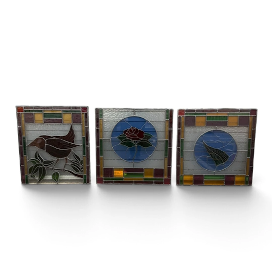 Li THREE STAINED GLASS PANELS Depicting a bird, rose and thi...