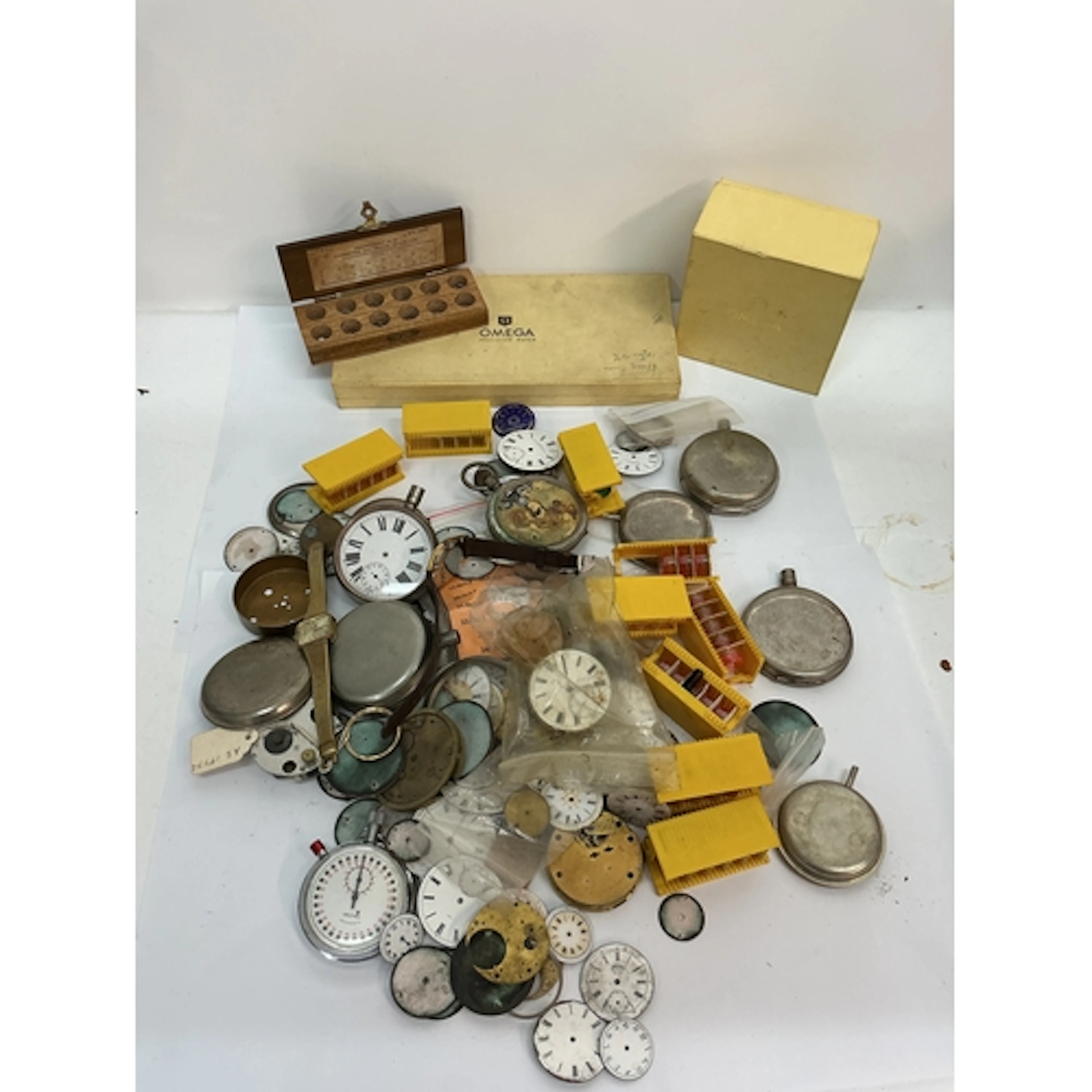 A quantity of assorted watch parts plus Omega boxes. Offered...
