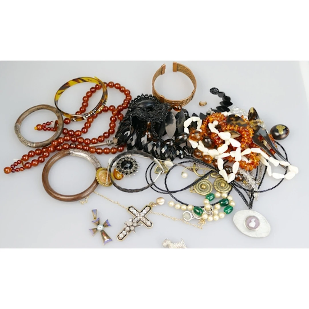 A selection of precious white metal and costume jewellery in...