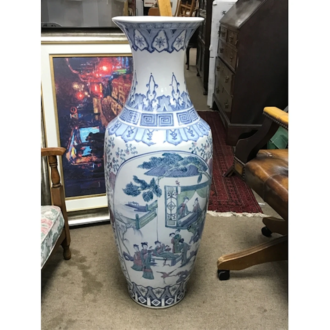 A Chinese floor vase featuring traditional figural land...