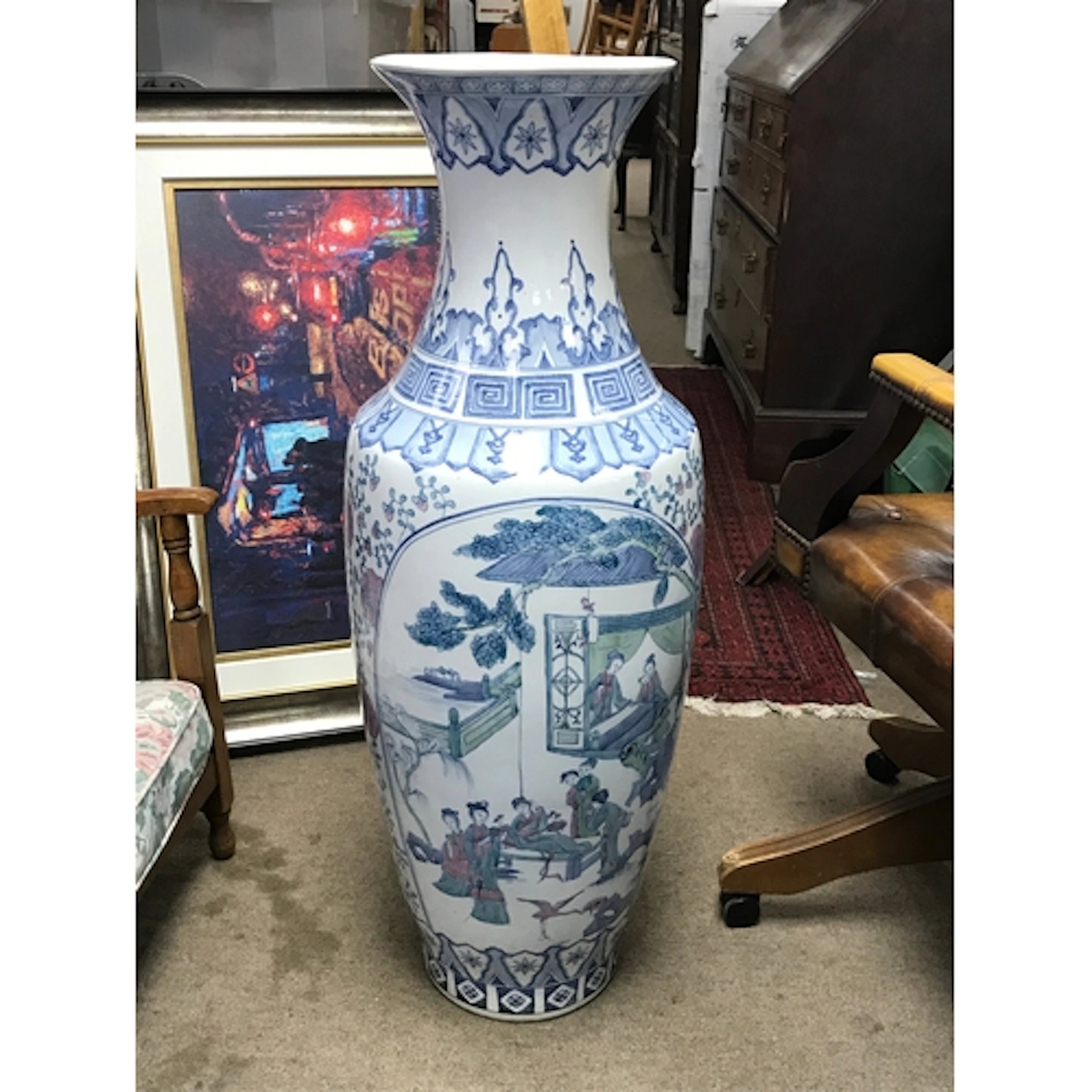 A Chinese floor vase featuring traditional figural land...