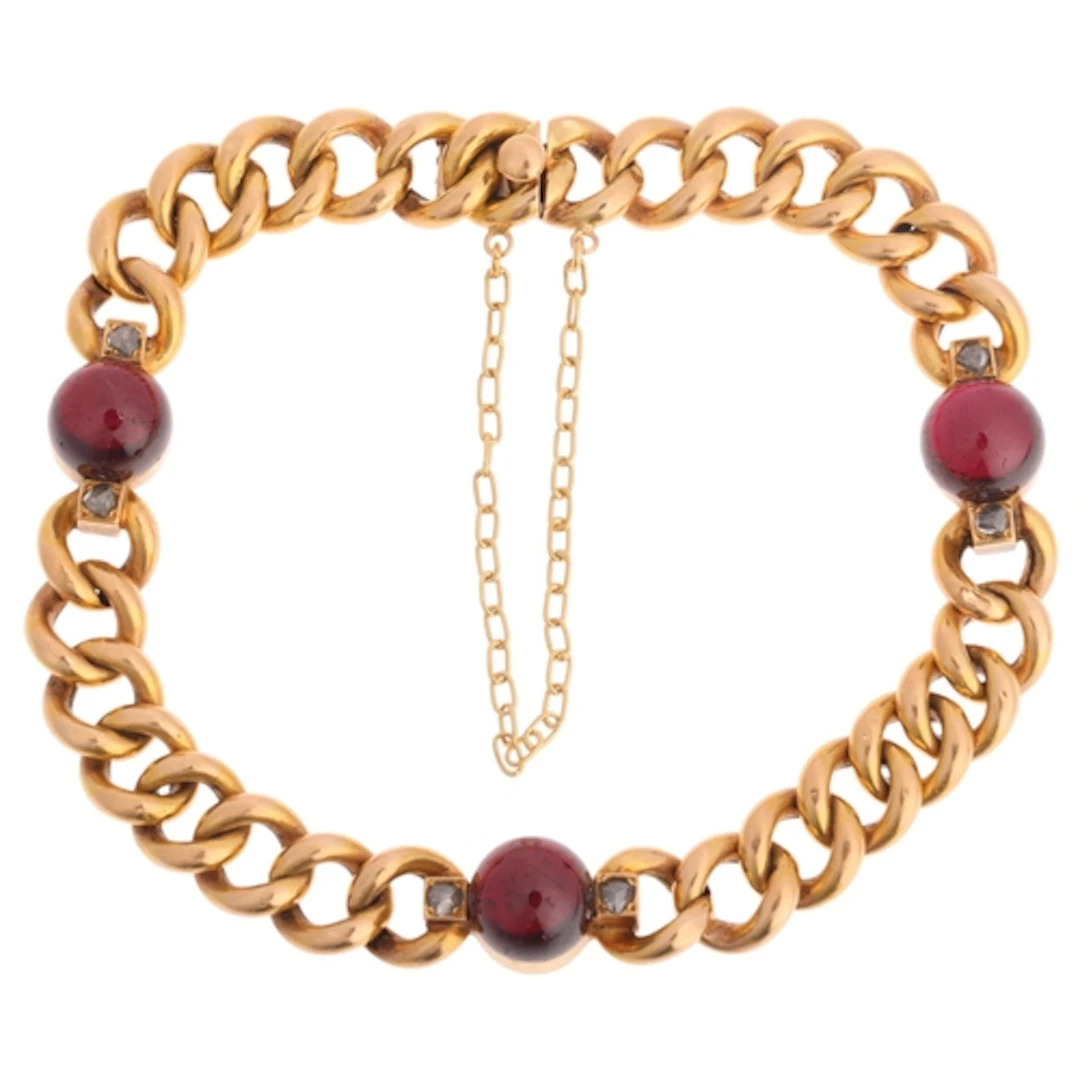 An Antique French 18ct gold garnet and diamond curb link bra...