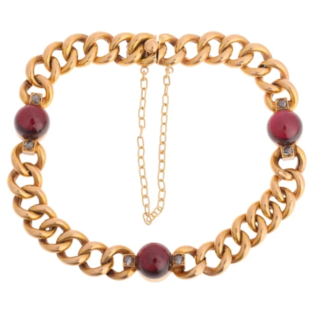 An Antique French 18ct gold garnet and diamond curb link bra...