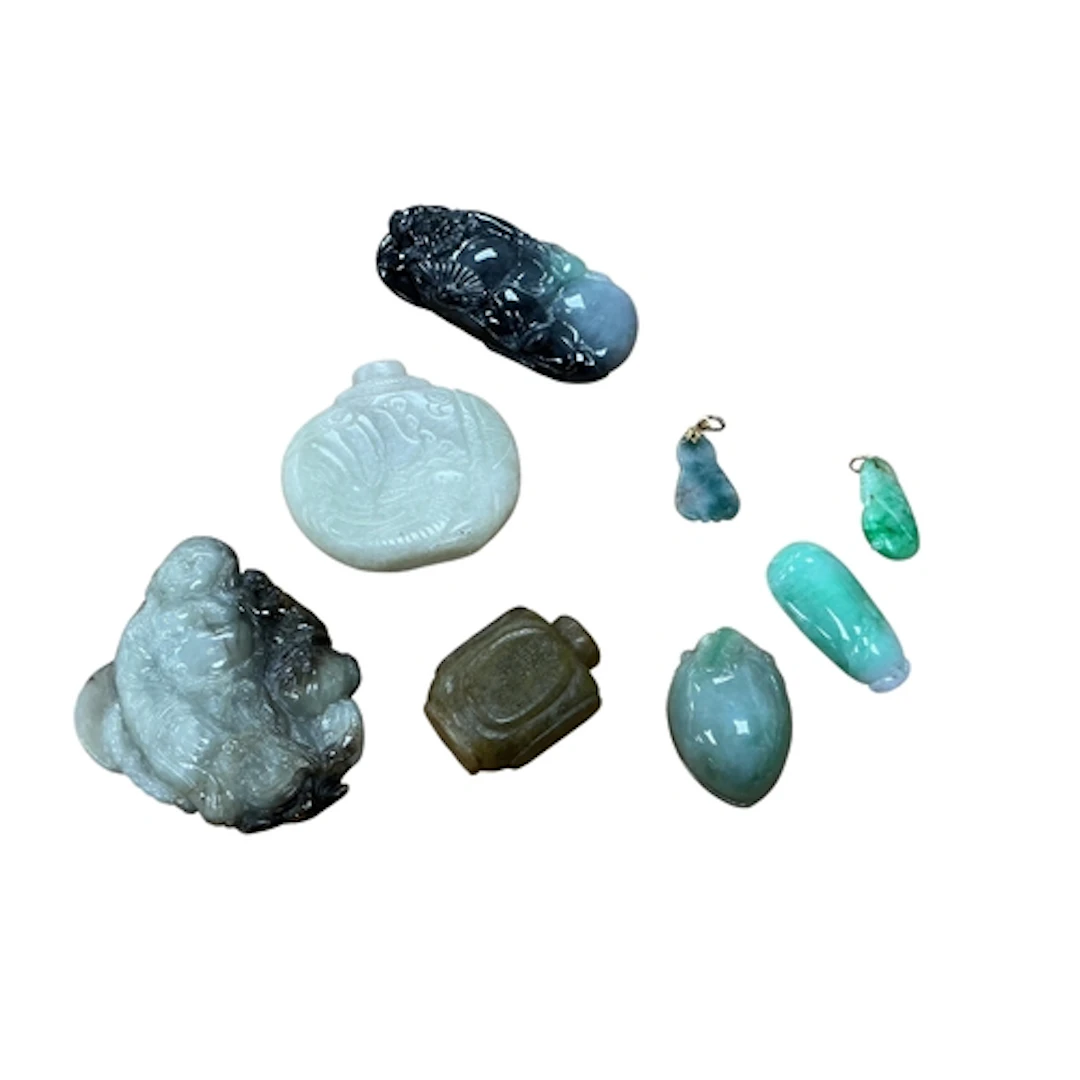 A group of Chinese jadeite carvings including two pendants w...
