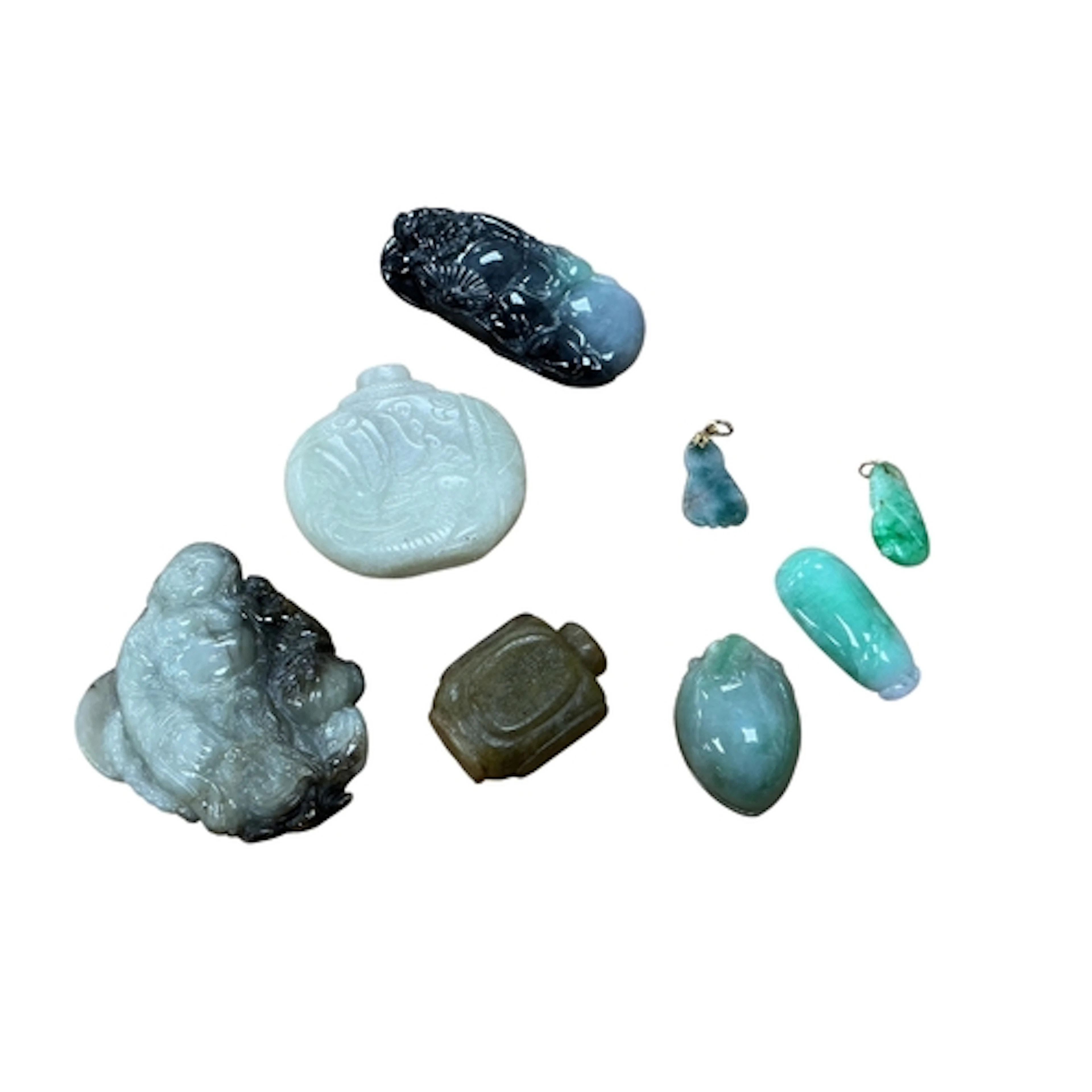 A group of Chinese jadeite carvings including two pendants w...