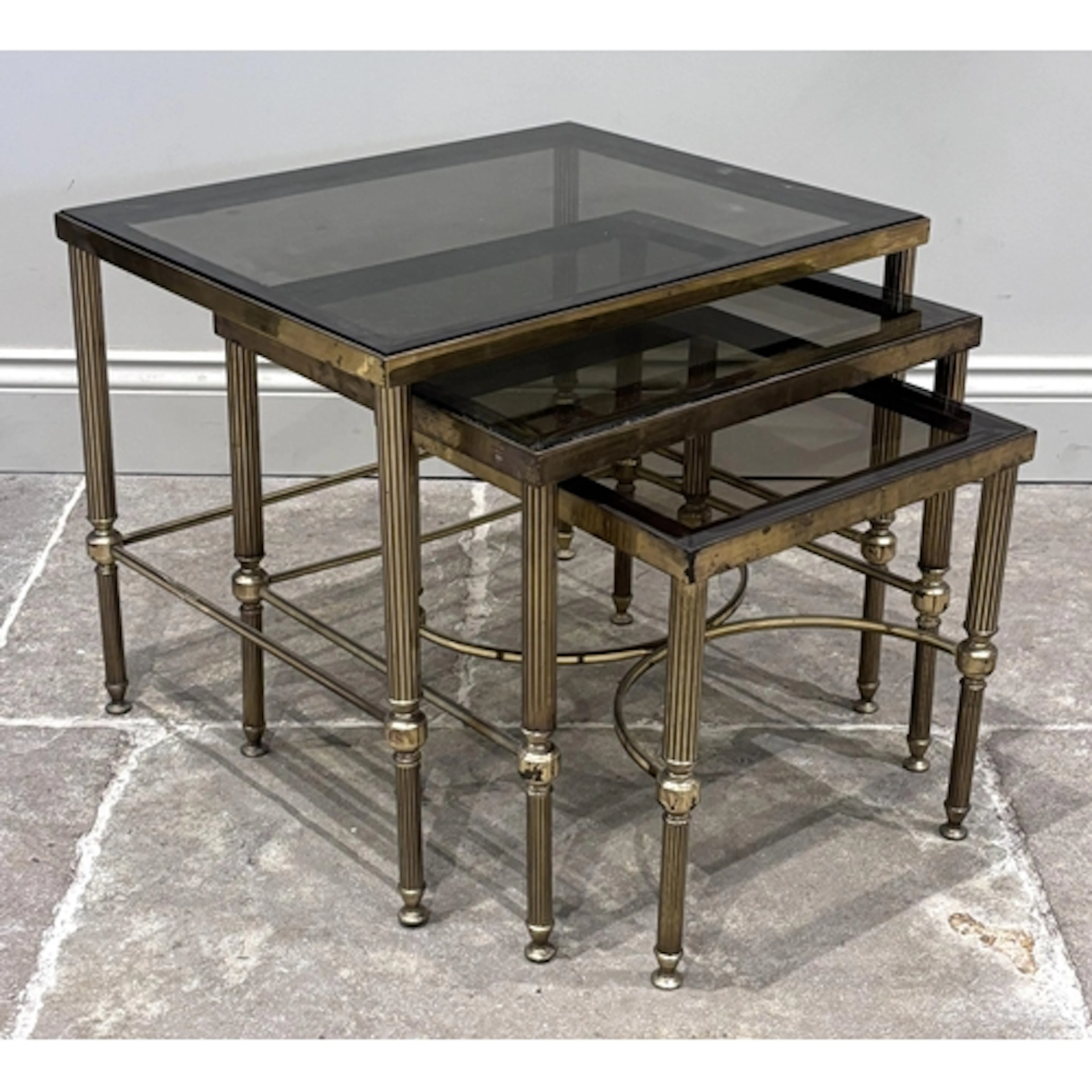 A nest of three tables in the manner of Maison Jansen, each ...