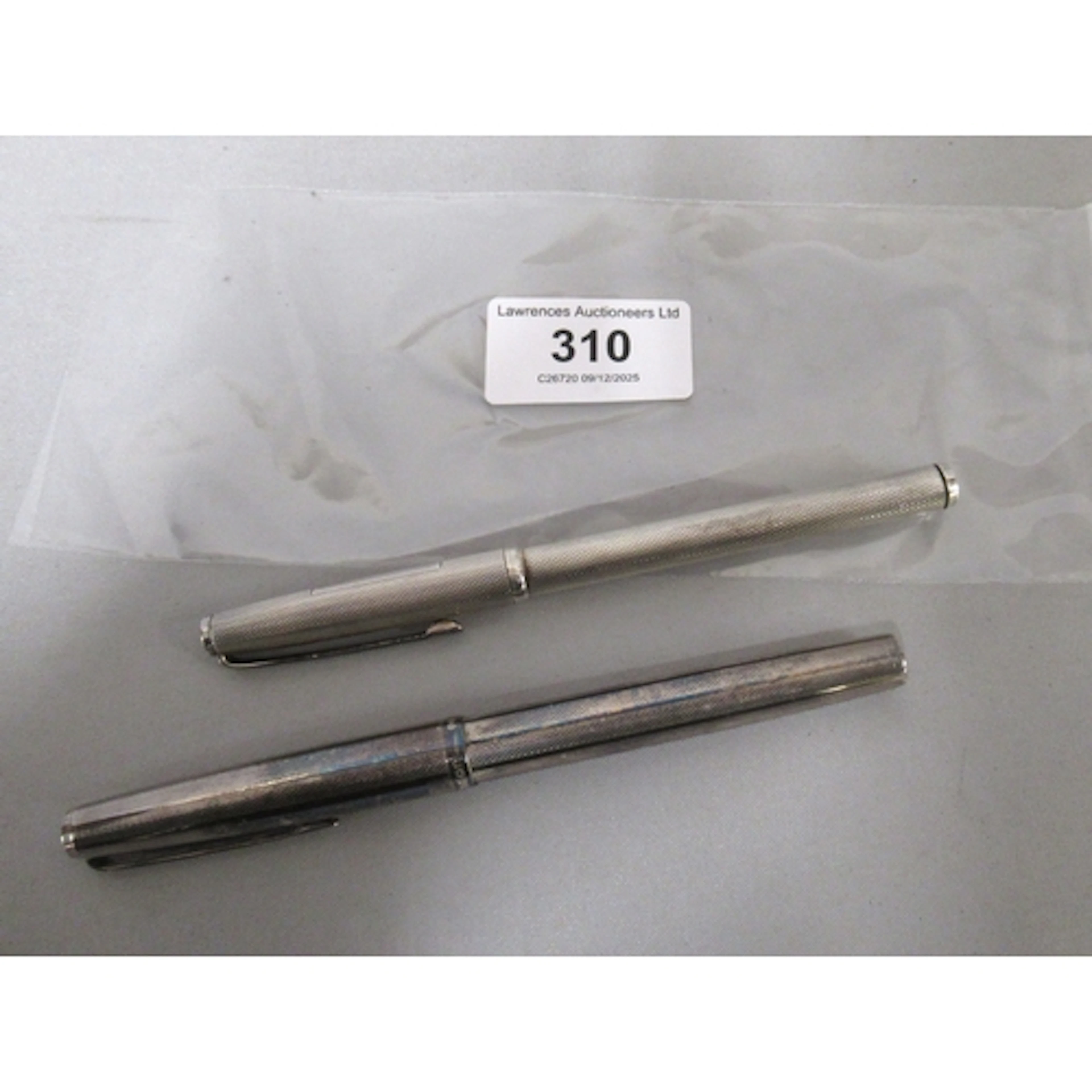 Two silver cased ballpoint pens, one by Asprey & Co
