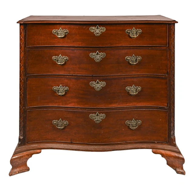 A George III serpentine mahogany chest of drawers, the four ...
