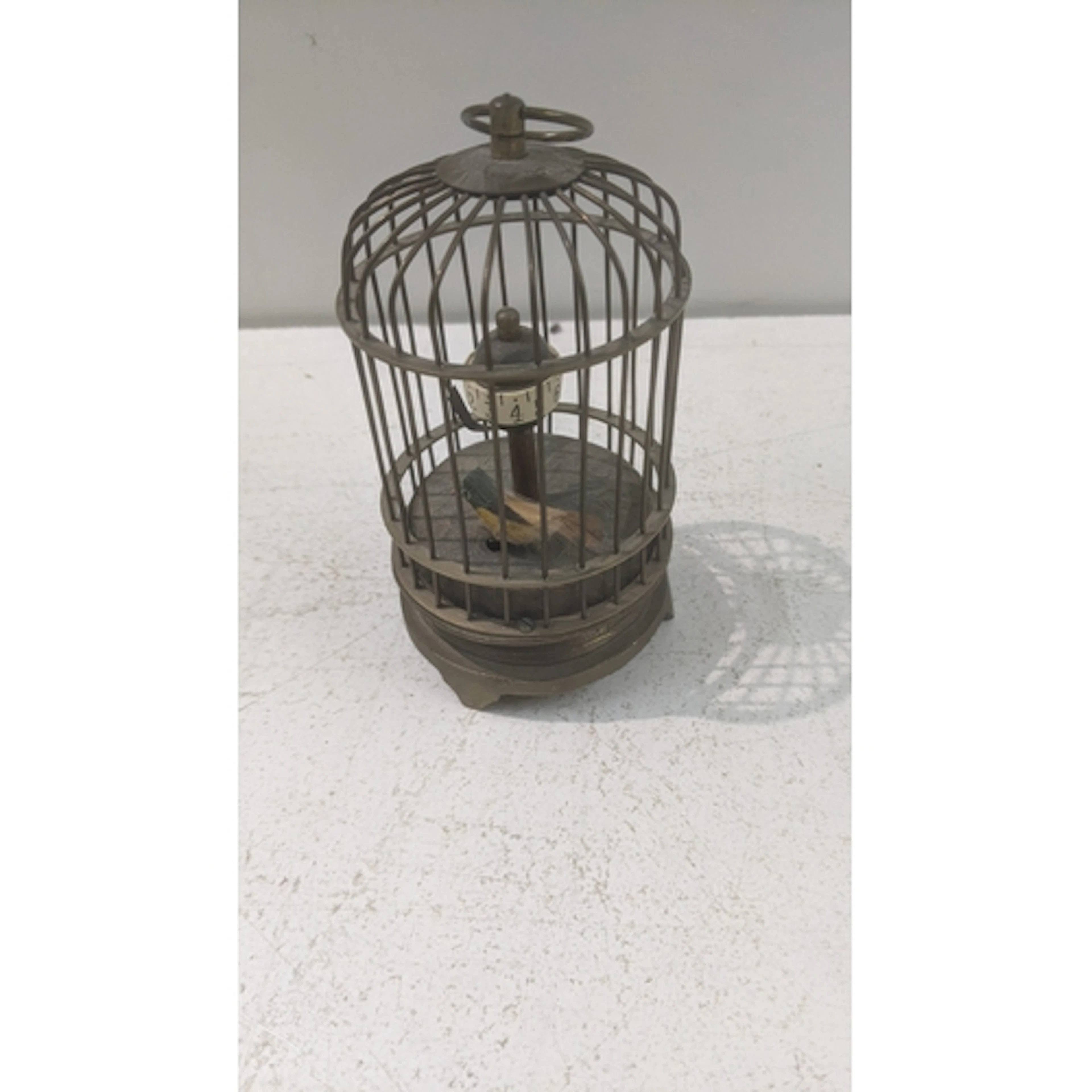 A vintage novelty brass bird cage automaton table clock Loca...