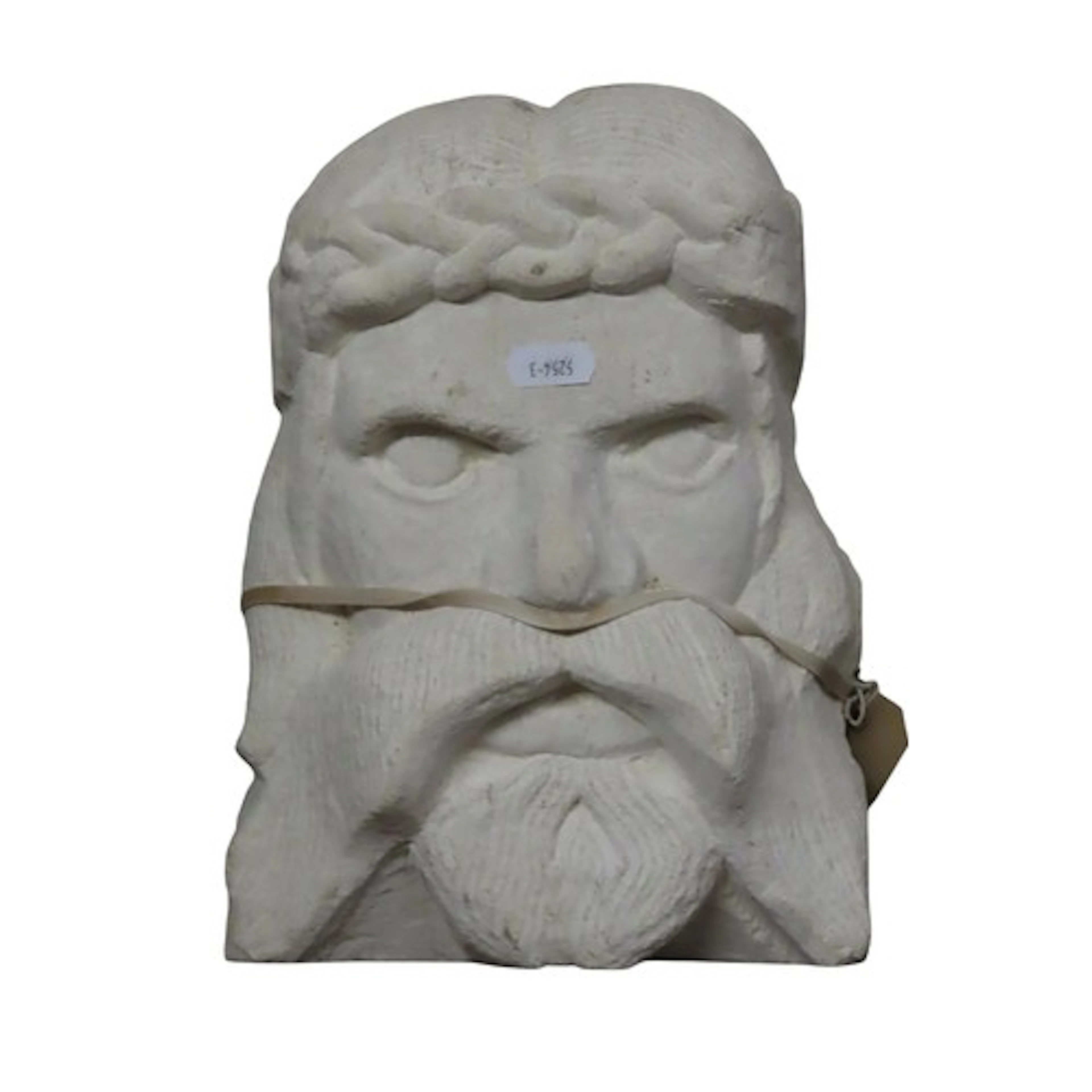 A carved limestone male face mask with Celtic head band 27 c...