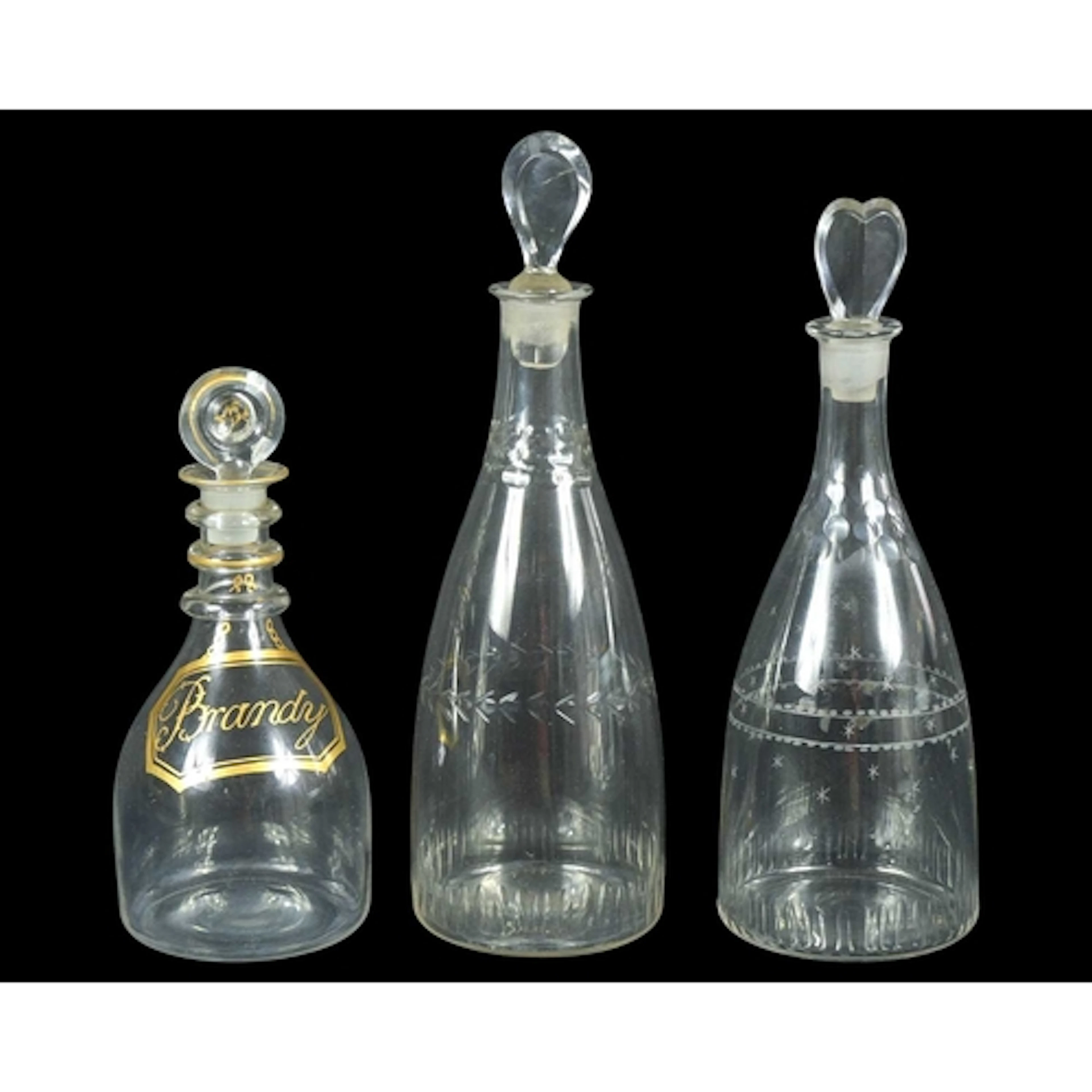 Three George III glass decanters and stoppers. The smallest,...