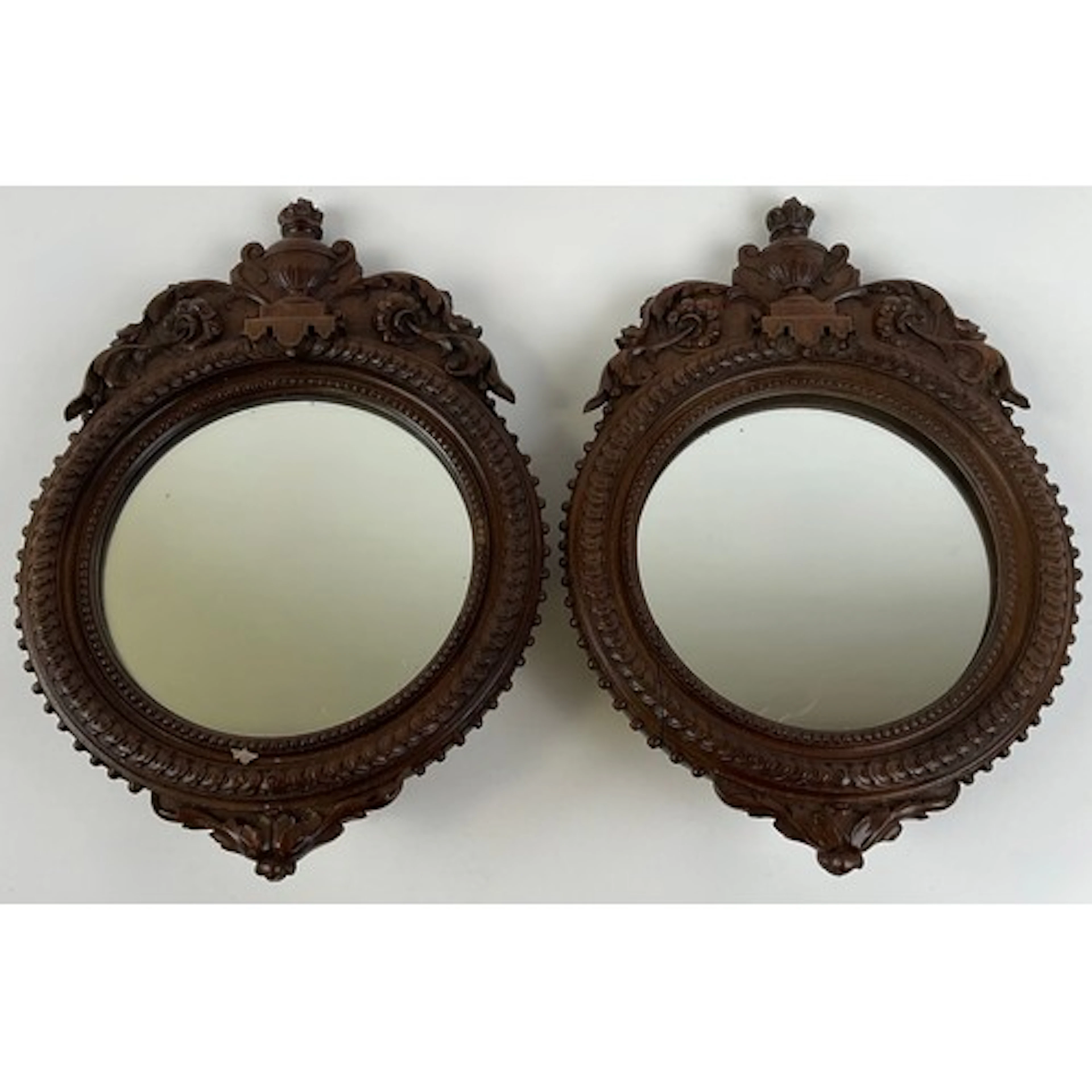 A pair of late 19th century walnut looking glasses, circular...