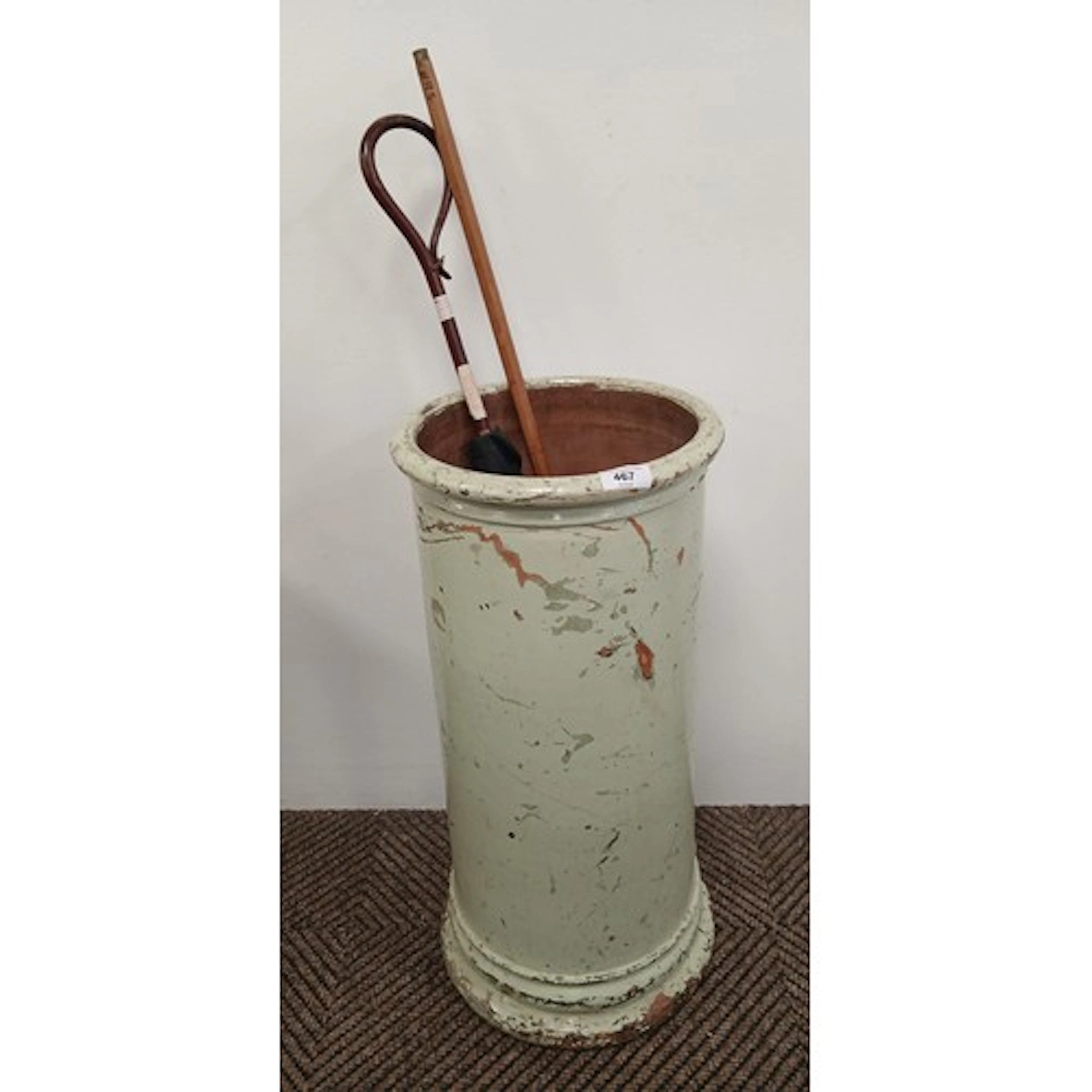 Circular painted terracotta stick stand, containing parasol ...