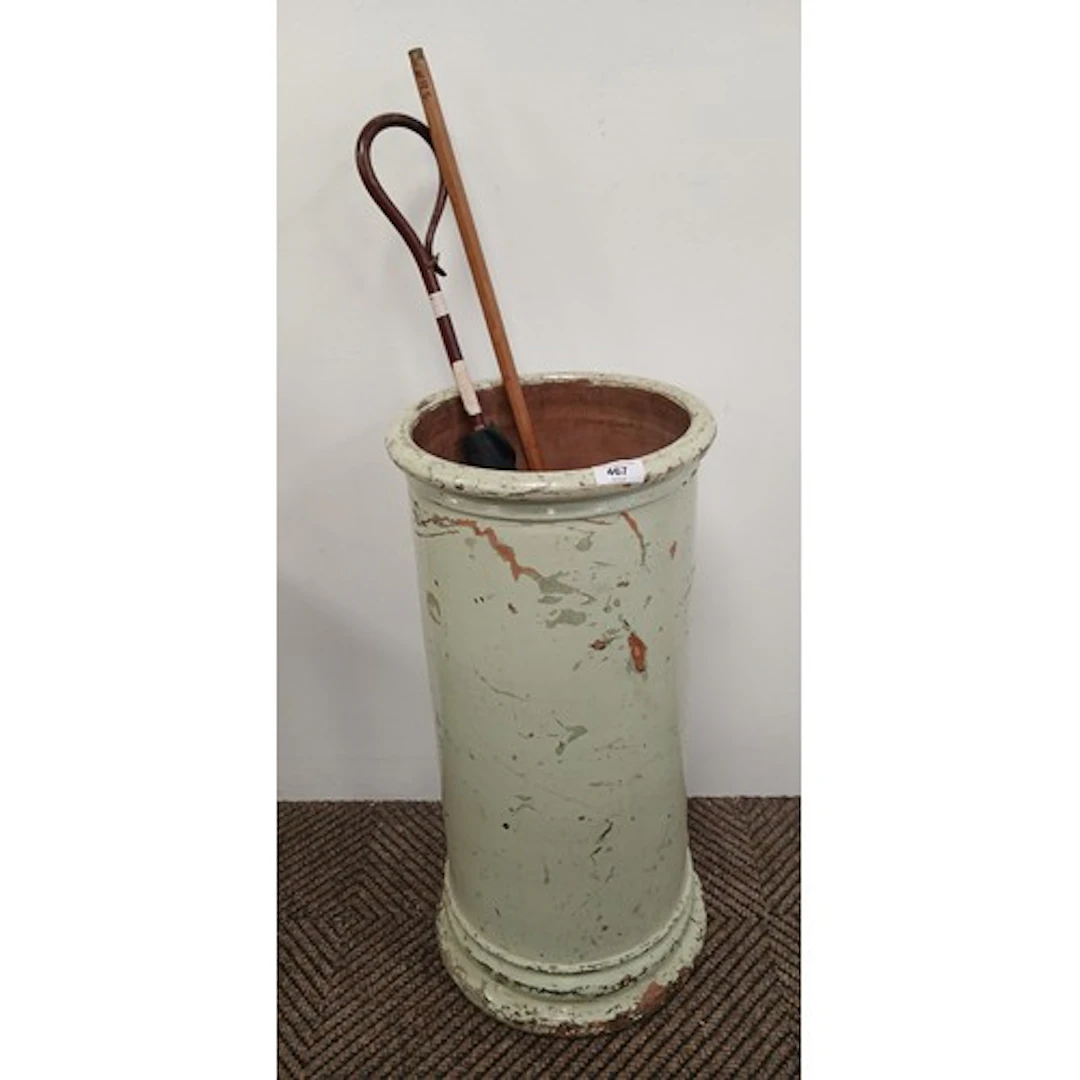 Circular painted terracotta stick stand, containing parasol ...