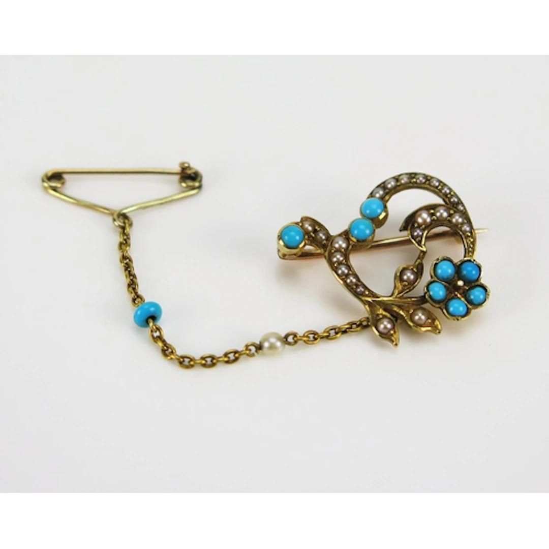 An antique FORGET ME NOT brooch set with turquoise and seed ...